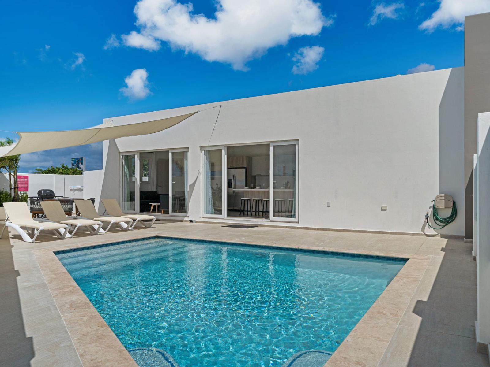 - Dive into your private pool under the clear blue sky for the ultimate vacation vibe - Sunbathe in comfort on the poolside loungers, surrounded by privacy walls for a secluded retreat - Perfect setting for a relaxing getaway with friends or family