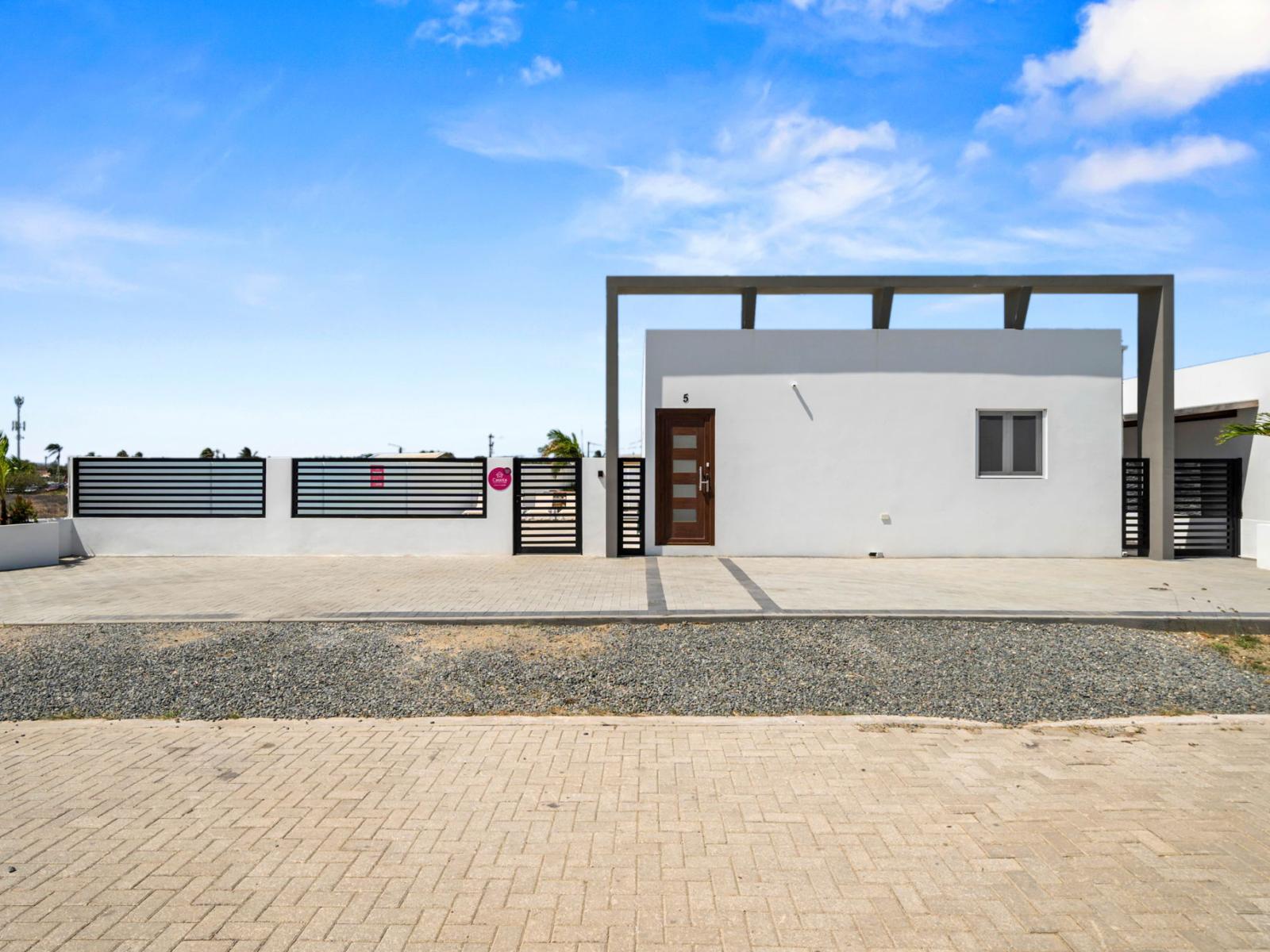 Modern home with a minimalist design, gated entrance, and sleek curb appeal.