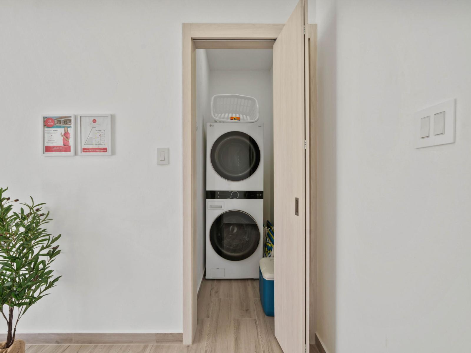 - Compact laundry space with a stacked washer and dryer for efficient use of space - Sliding door keeps the area neatly tucked away when not in use - Conveniently located for easy access while maintaining a clean, minimalist design