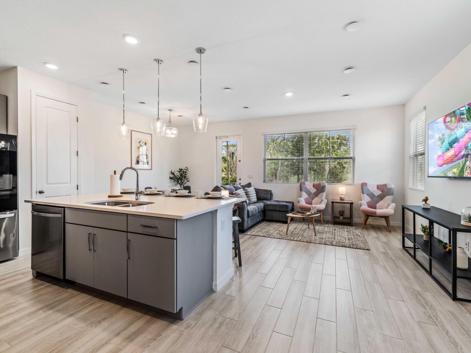 Discover the joy of cooking in the fully equipped and modern kitchen - Modern kitchen island with seating, perfect for entertaining - Open concept layout combining the living and kitchen stylish lighting fixtures enhance the inviting atmosphere