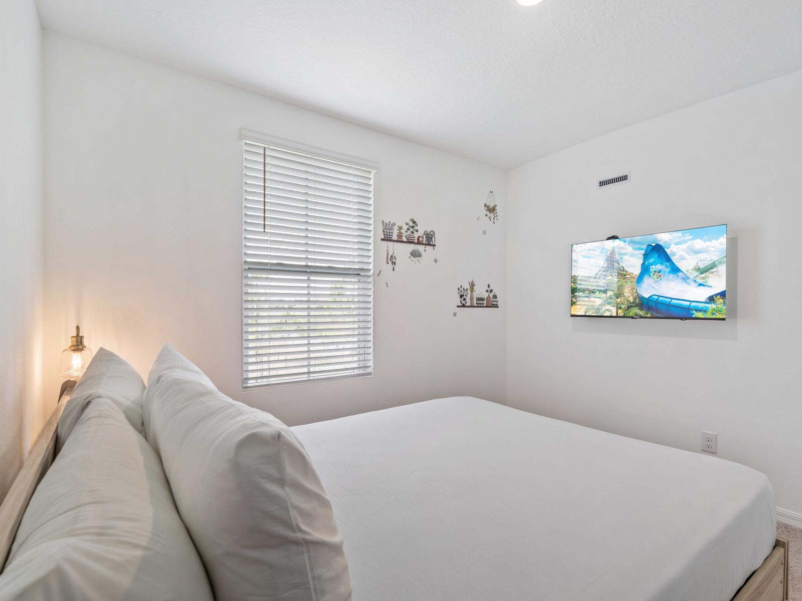 Experience the ultimate in relaxation in the serene and spacious bedroom retreat - Features  a comfortable queen size bed and soft white linens - Decorated with charming wall decals and smart TV, bright room with peaceful ambiance