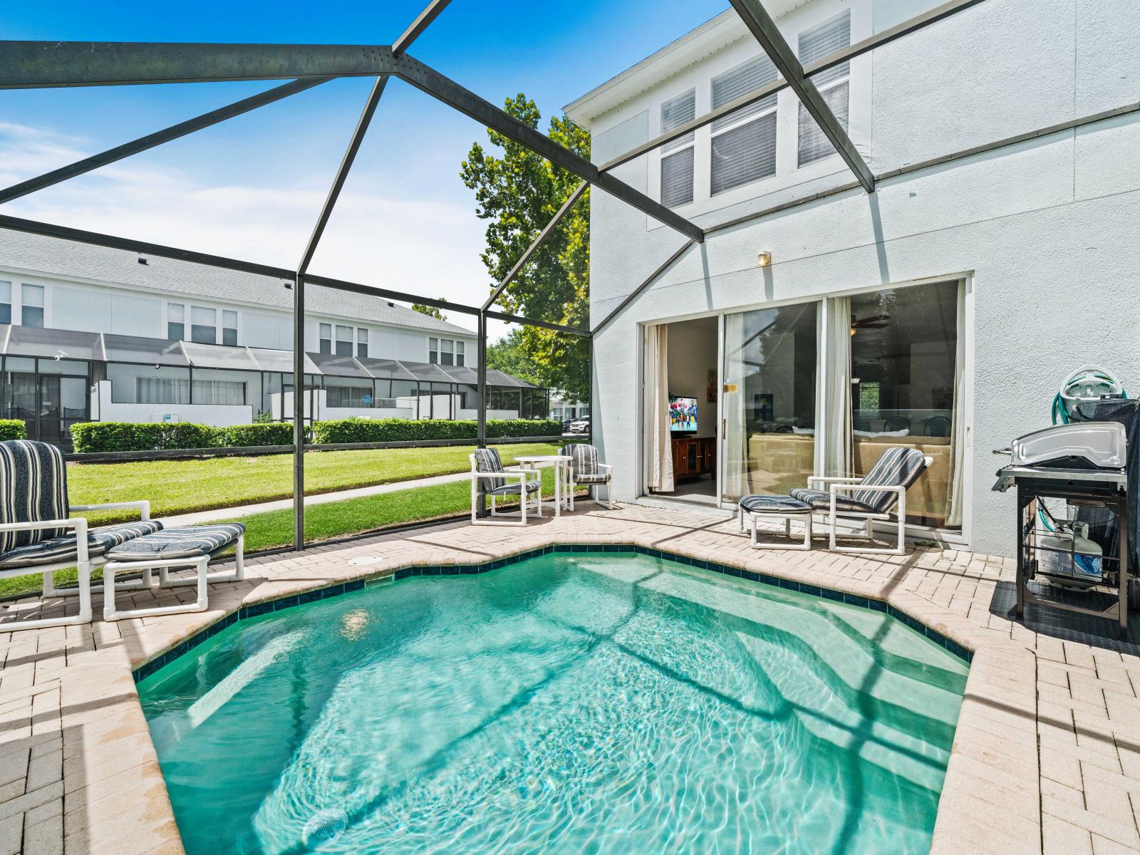 Unwind in this private pool area, perfect for a refreshing dip on a sunny day - Enjoy outdoor grilling with the convenient BBQ setup, ideal for family gatherings - Comfortable seating and a serene environment create the ultimate backyard oasis