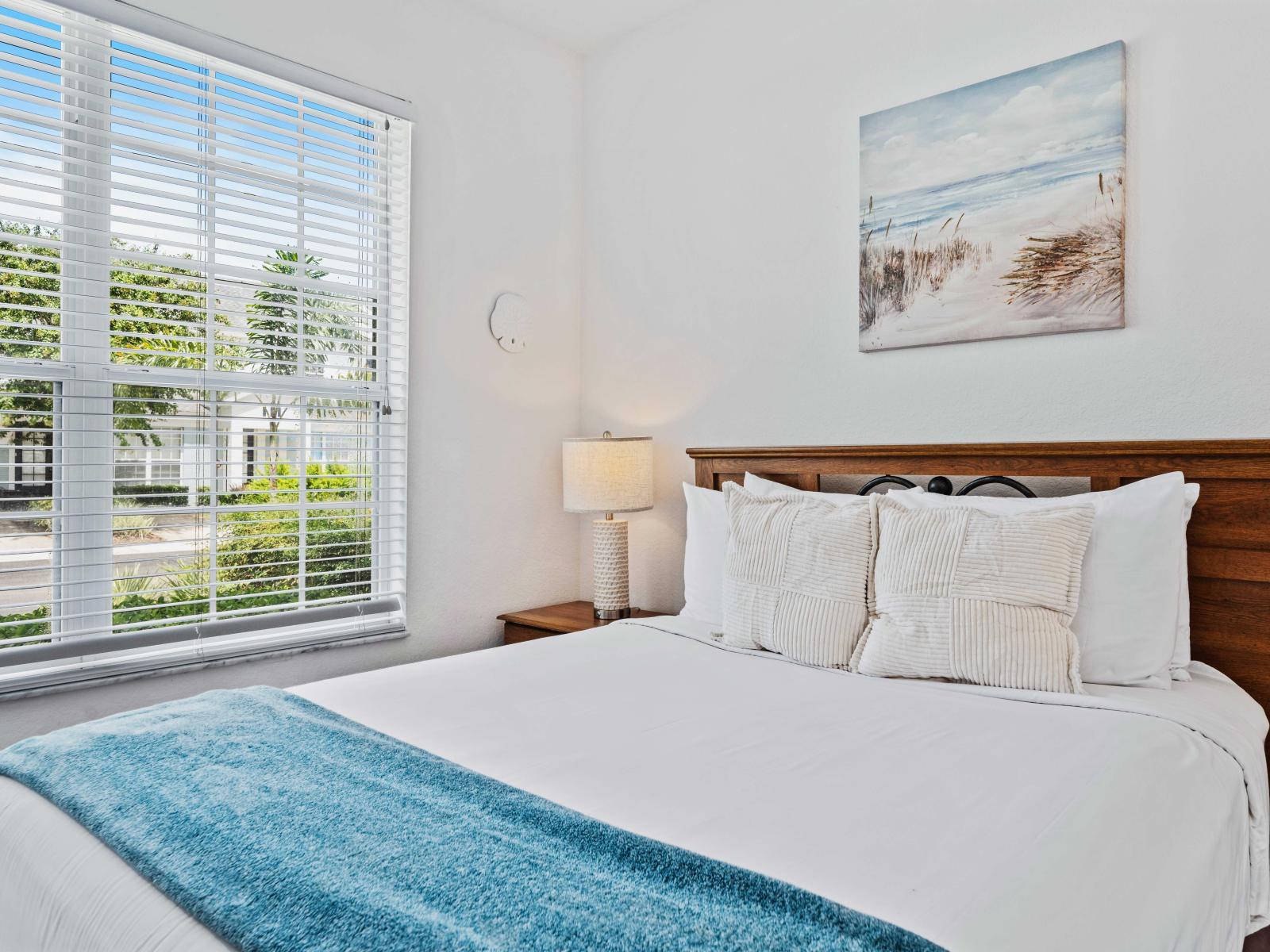 Cozy bedroom featuring a comfortable queen-size bed with plush pillows and a soft blanket - Large window provides plenty of natural light and a refreshing view - Room includes a private bathroom, ensuring convenience and privacy for guests