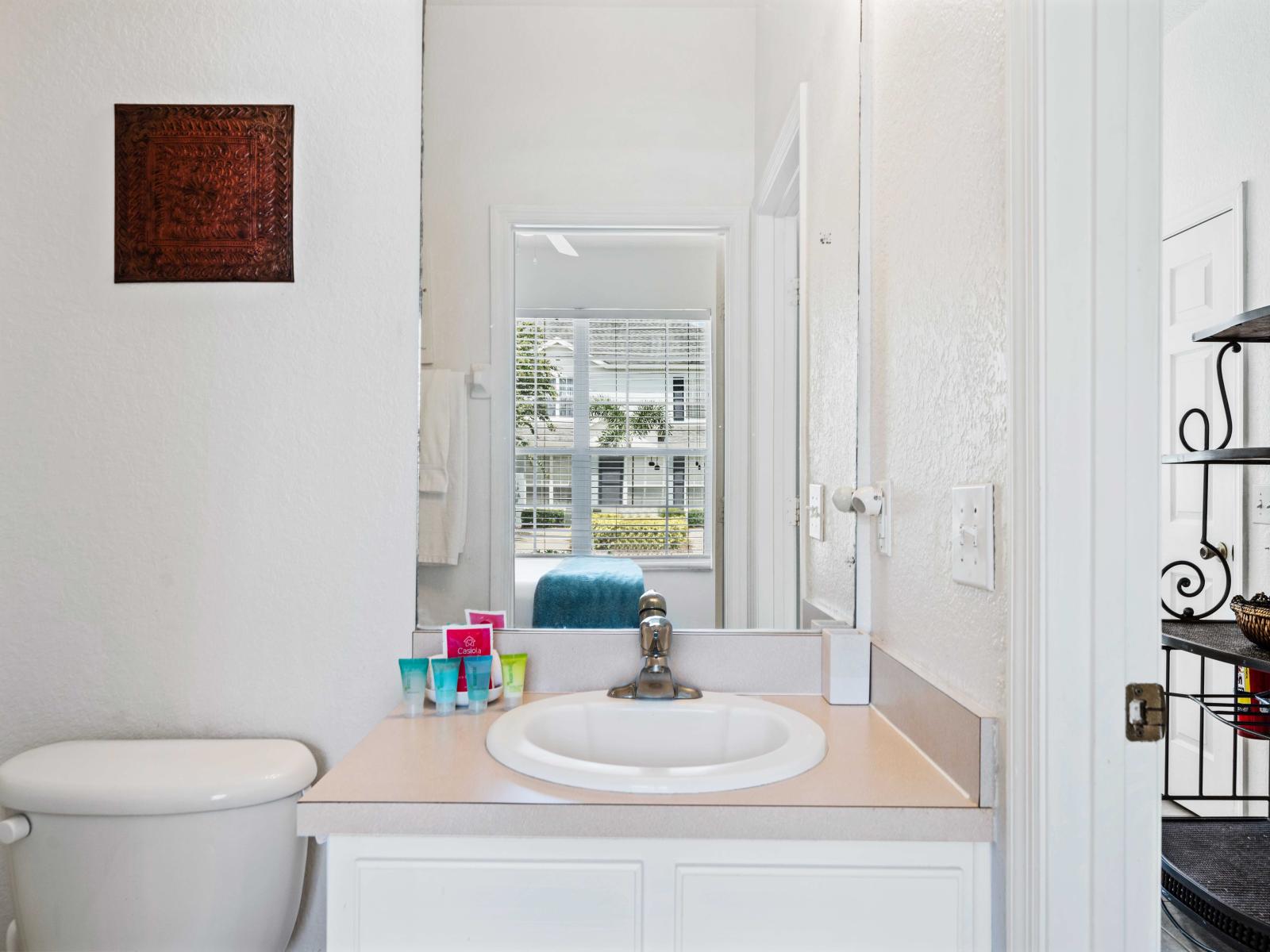 Bright and modern bathroom featuring a sleek vanity and well-lit sink - Equipped with essential toiletries for your convenience - Conveniently located next to the bedroom, providing a private and refreshing space to start your day