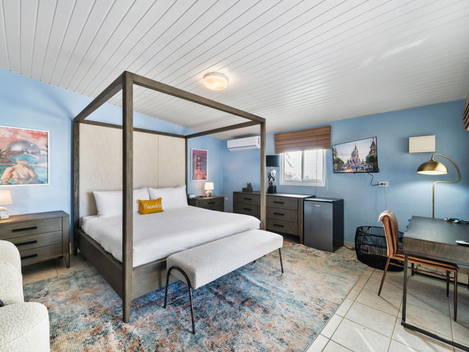 - Inviting bedroom featuring a queen-size bed and serene blue walls - A cozy workspace and modern furnishings create a perfect blend of comfort and functionality - Soft lighting and thoughtful decor make this a stylish retreat for rest and relaxation