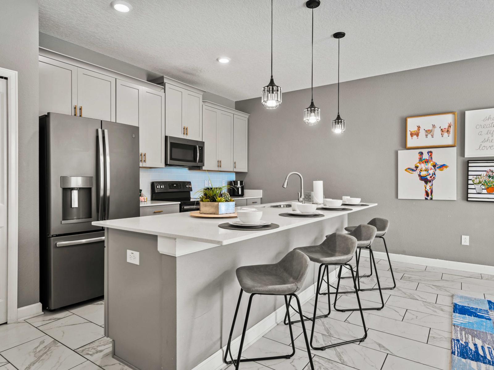 - Modern kitchen with a cozy breakfast bar, perfect for casual dining - Stylish pendant lighting adds a touch of elegance to this functional and inviting space - Enjoy the perfect blend of design, comfort, and convenience in this culinary hub