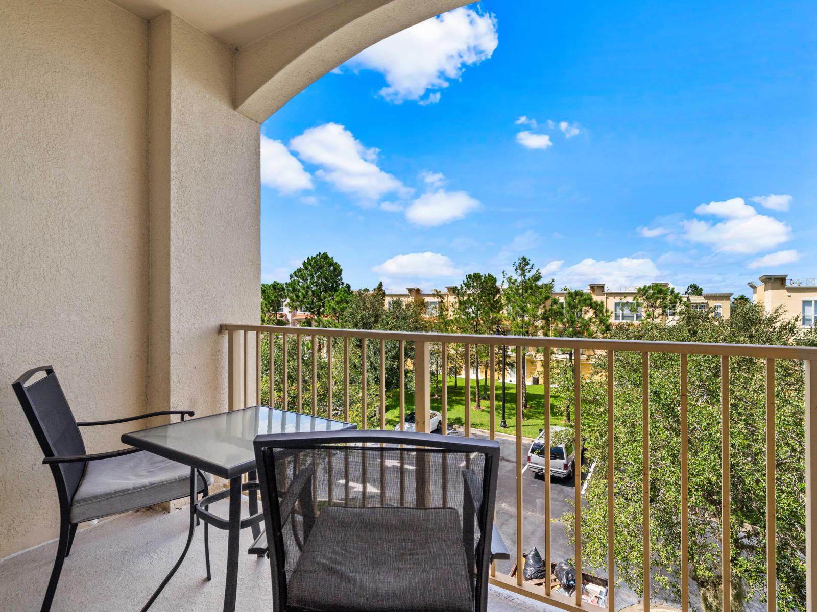 - Balcony with cozy seating perfect for enjoying morning coffee or evening outdoors - Scenic views of the surrounding greenery providing a peaceful and serene atmosphere - Shaded area under a stylish archway offering a spot to take in the fresh air