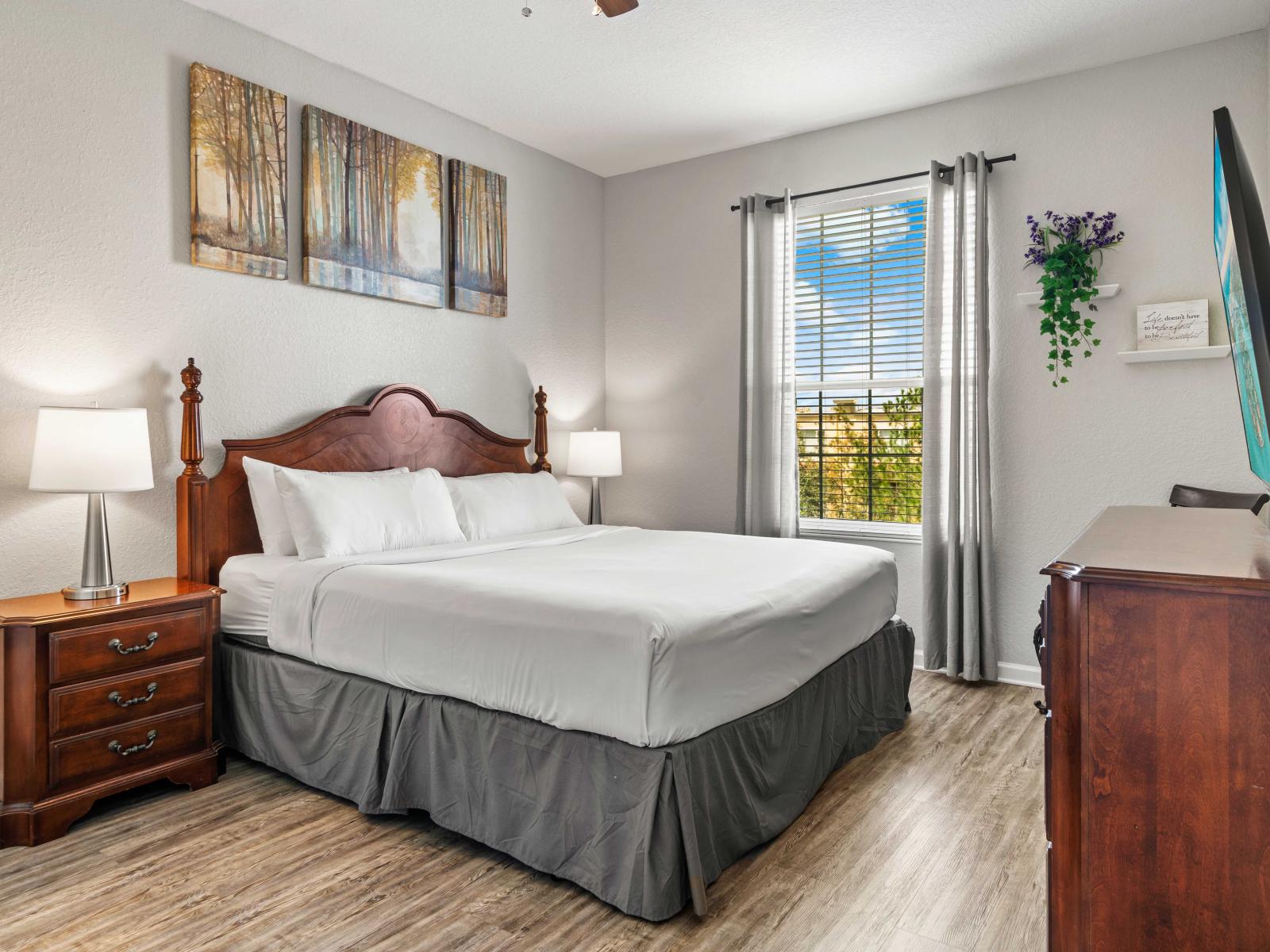 - Cozy bedroom with a king-sized bed & an attached private bath makes an easy access - Large window brings in natural light enhancing the rooms ambiance with calming decor - Wooden dressers offer convenient storage and Smart TV adds for your comfort