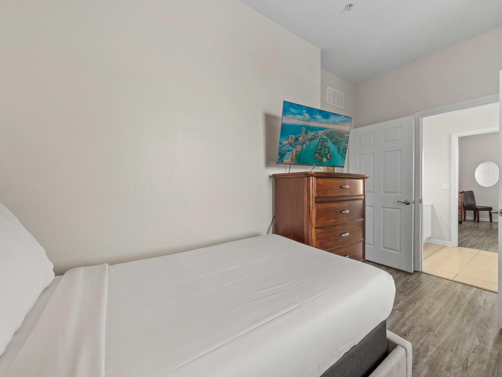 - Charming  bedroom with a comfortable twin beds along with attach private bathroom - Equipped with a wooden dresser and a smart TV for relaxation - Room has easy access to the adjacent areas making it convenient and well-connected within the home