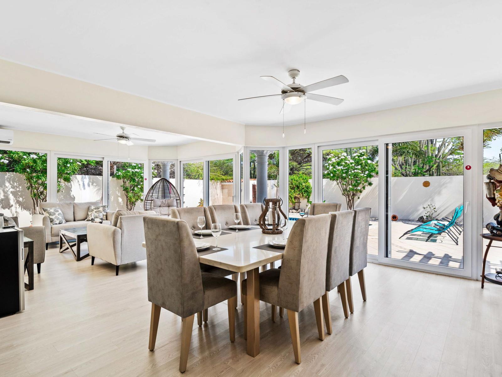 Gather around the elegant dining table, perfect for sharing meals and making memories - Dine in style in a spacious area designed for 8 persons - Enjoy meals in a bright and airy atmosphere with panoramic windows and pool views