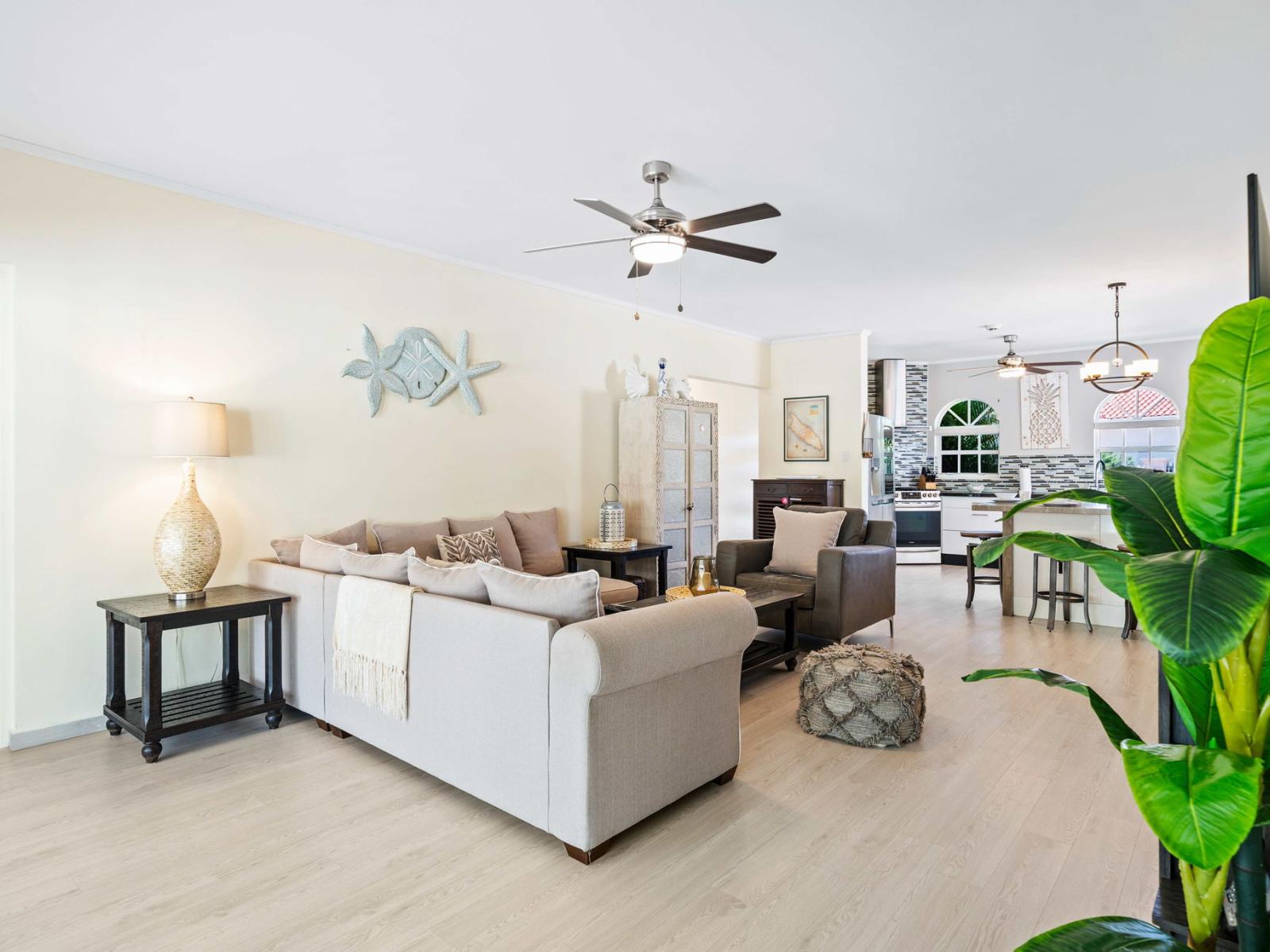 Gather in a open design living space with modern amenities and tasteful decor - Features comfortable furnishings and a serene ambiance for relaxation - A balance of sophistication and comfort, featuring elegant yet inviting furniture