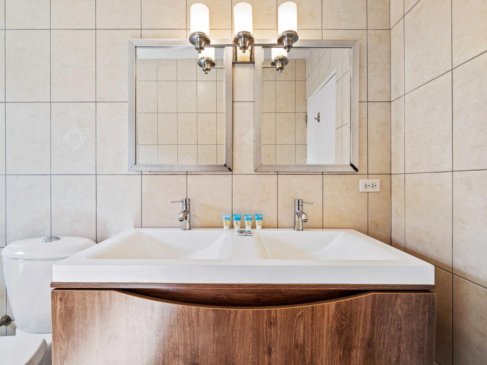 Indulge in luxury and relaxation in the meticulously designed bathroom sanctuary - Chic design featuring a sleek vanity and upscale lighting elements, combining form and function - Contemporary fixtures add a touch of indulgence