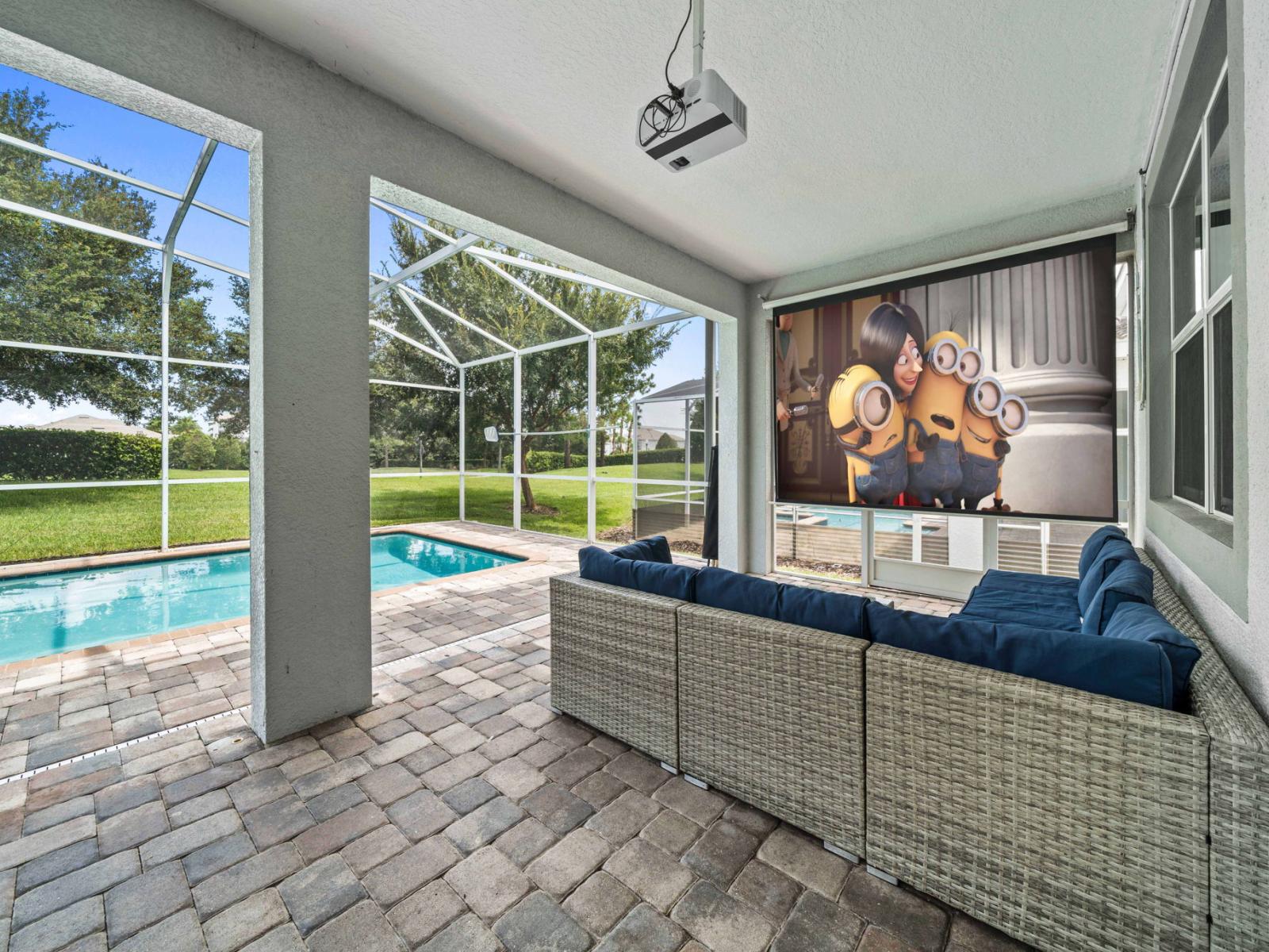 - Outdoor lounge area is a perfect spot for movie nights or simply relaxing, featuring a large screen projector - The space is adjacent to a private pool with a screened enclosure - Cozy seating, modern amenities, and the beautiful outdoor setting