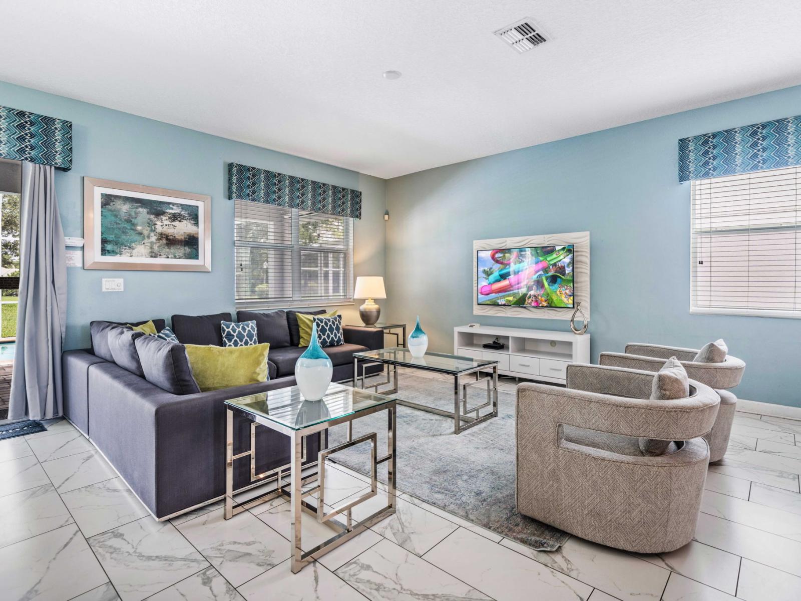 - Living area offers a comfortable and stylish retreat, with modern decor and smart TV for entertainment - Sliding glass doors provide access to backyard and pool, allowing for easy indoor-outdoor living - Thoughtful arrangement of furniture & decor