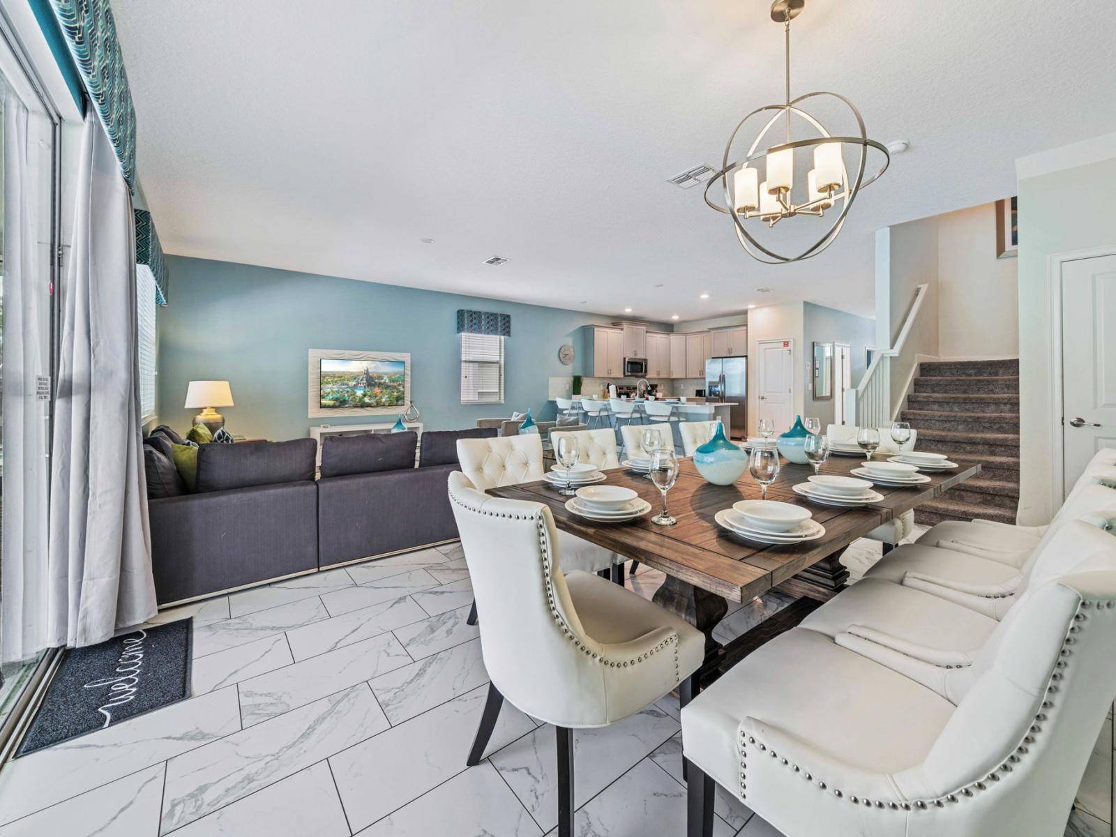 - Open-plan dining and living area is perfect for socializing, featuring a modern dining table set for eight - Stylish decor complemented by contemporary furnishings and decorative accents - Designed to be both functional and aesthetically pleasing