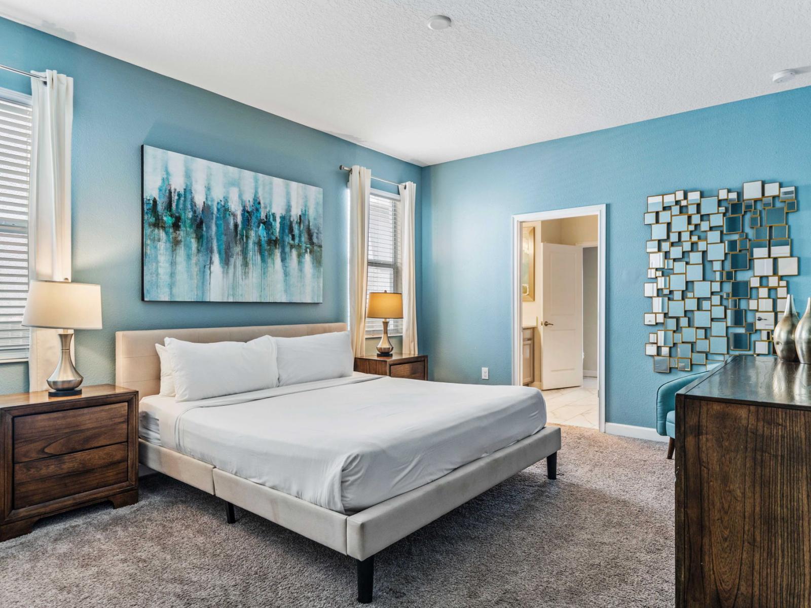 - Luxurious master bedroom featuring a king-sized bed with high-quality linens - Includes nightstands with lamps, a dresser, and stylish wall art - Spacious layout with an en-suite bathroom for added privacy and convenience