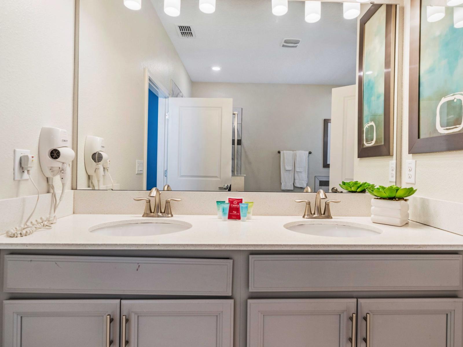 - Recharge in the bathroom with a double sink vanity with sleek fixtures - Bright lighting and wall-mounted hairdryers enhance the functionality - The spacious counter area is equipped with essential amenities, ensuring a comfort and convenience