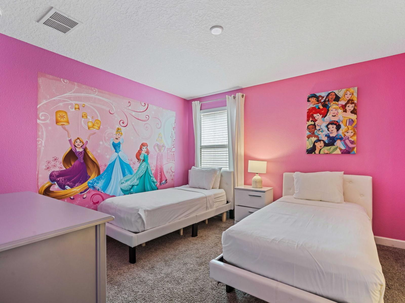 - Fun and vibrant children's bedroom with twin beds and Disney Princess Theme  - Themed wall mural and bright pink walls designed to delight young guests - Equipped with a dresser and bedside table with a lamp for convenience and storage