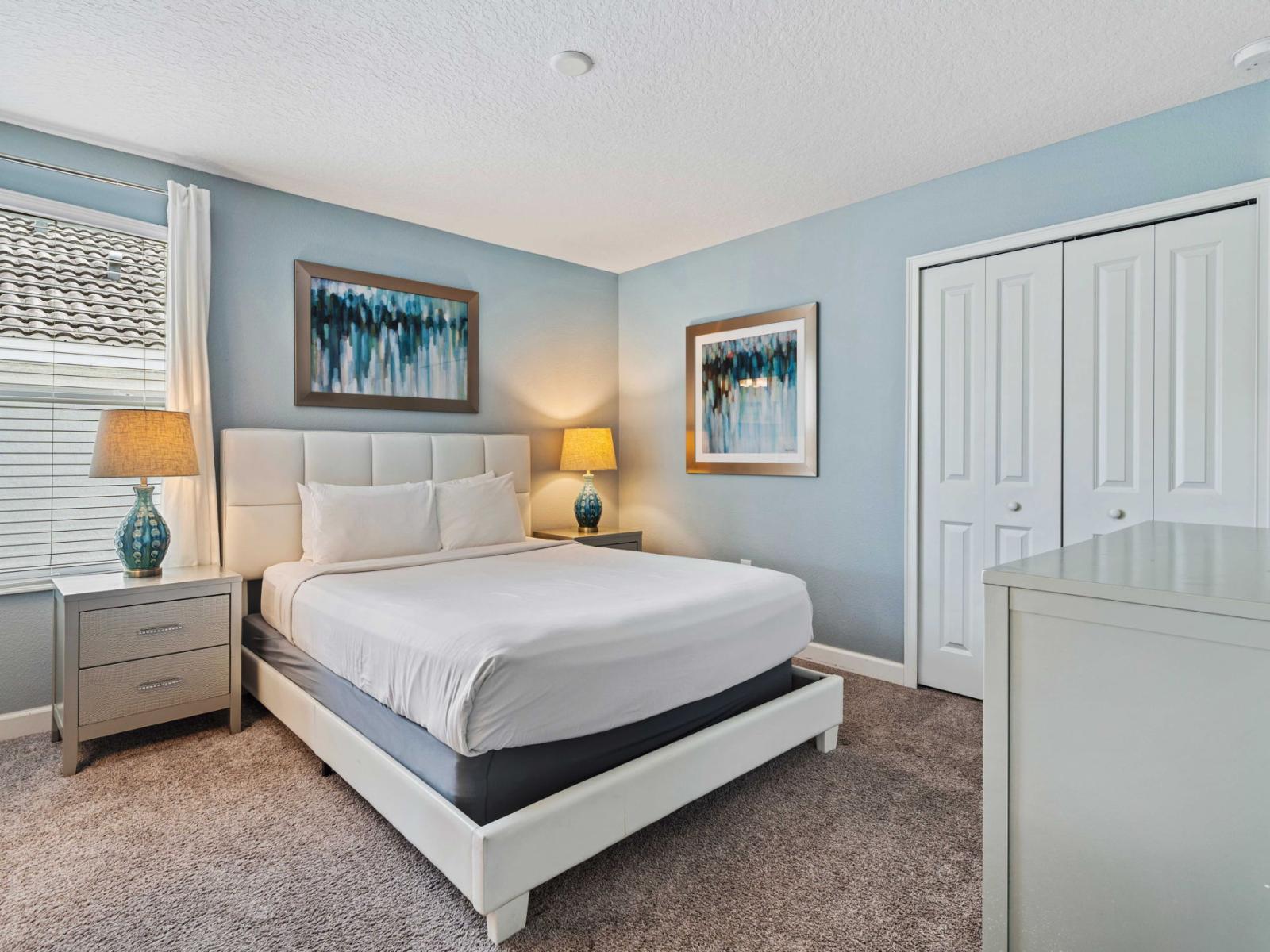 - Cozy bedroom with a queen-sized bed, smart TV and soft, plush bedding - Tastefully decorated with modern furniture and calming color tones - Large window allowing natural light to fill the room, creating a peaceful ambiance