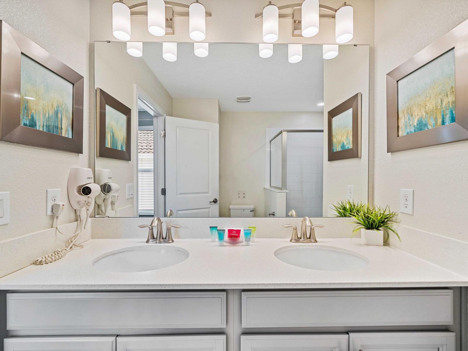 - Recharge in the bathroom with a double sink vanity with sleek fixtures - Bright lighting and wall-mounted hairdryers enhance the functionality - The spacious counter area is equipped with essential amenities, ensuring a comfort and convenience