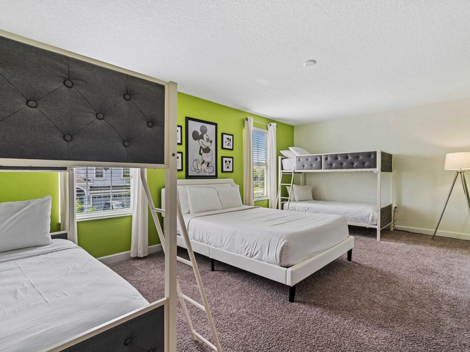 - This spacious and welcoming bedroom featuring two bunk beds and a comfortable double bed - Charming Mickey Mouse artwork, adding a touch of fun and whimsy to the room's decor - The modern furnishings and floor space ensure an enjoyable stay