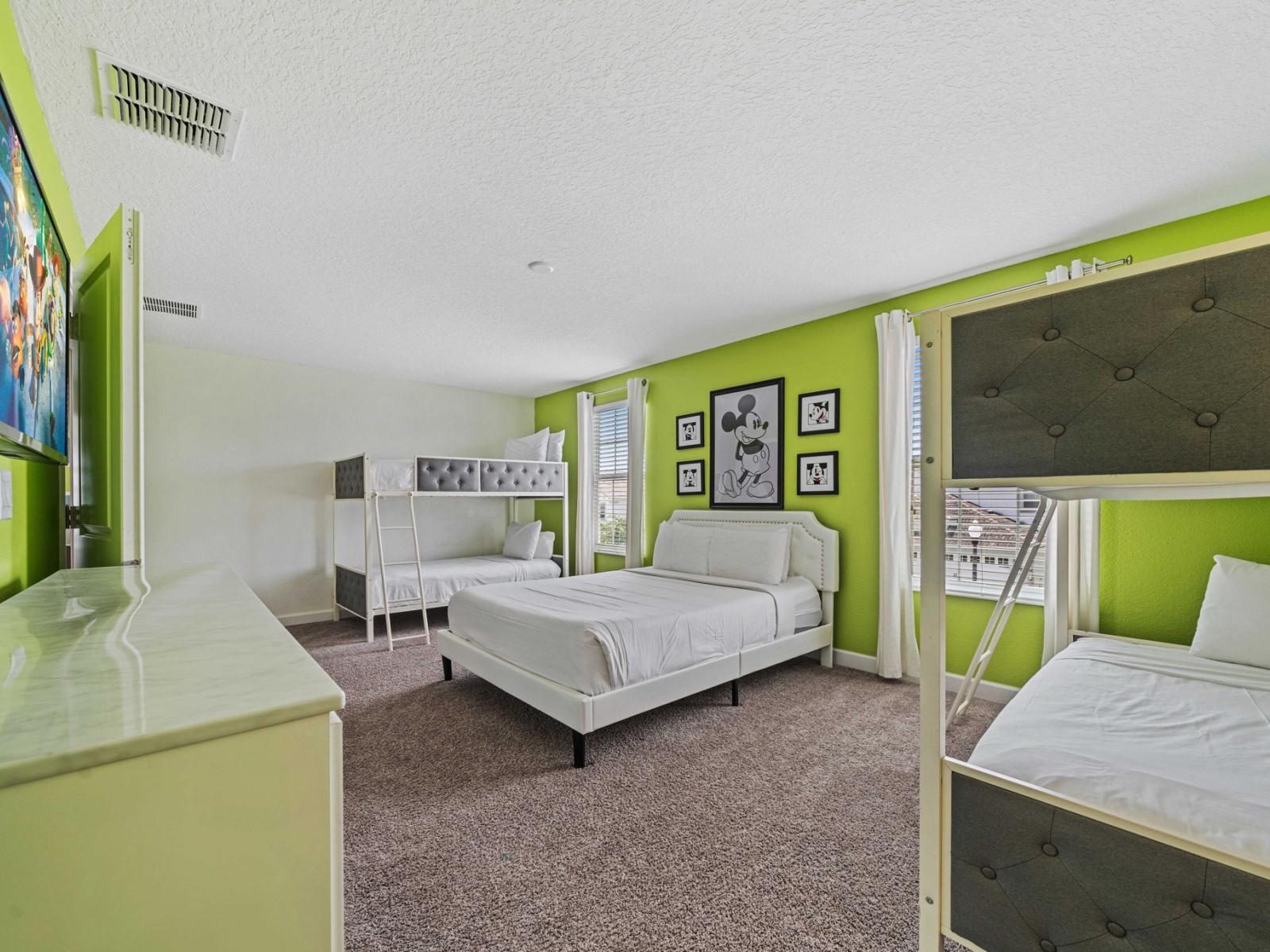 - This spacious bedroom is perfect for families, featuring multiple beds including - Vibrant green walls are adorned with playful Mickey Mouse-themed artwork, creating a fun atmosphere - Smart TV for a delightful space for kids to relax and enjoy