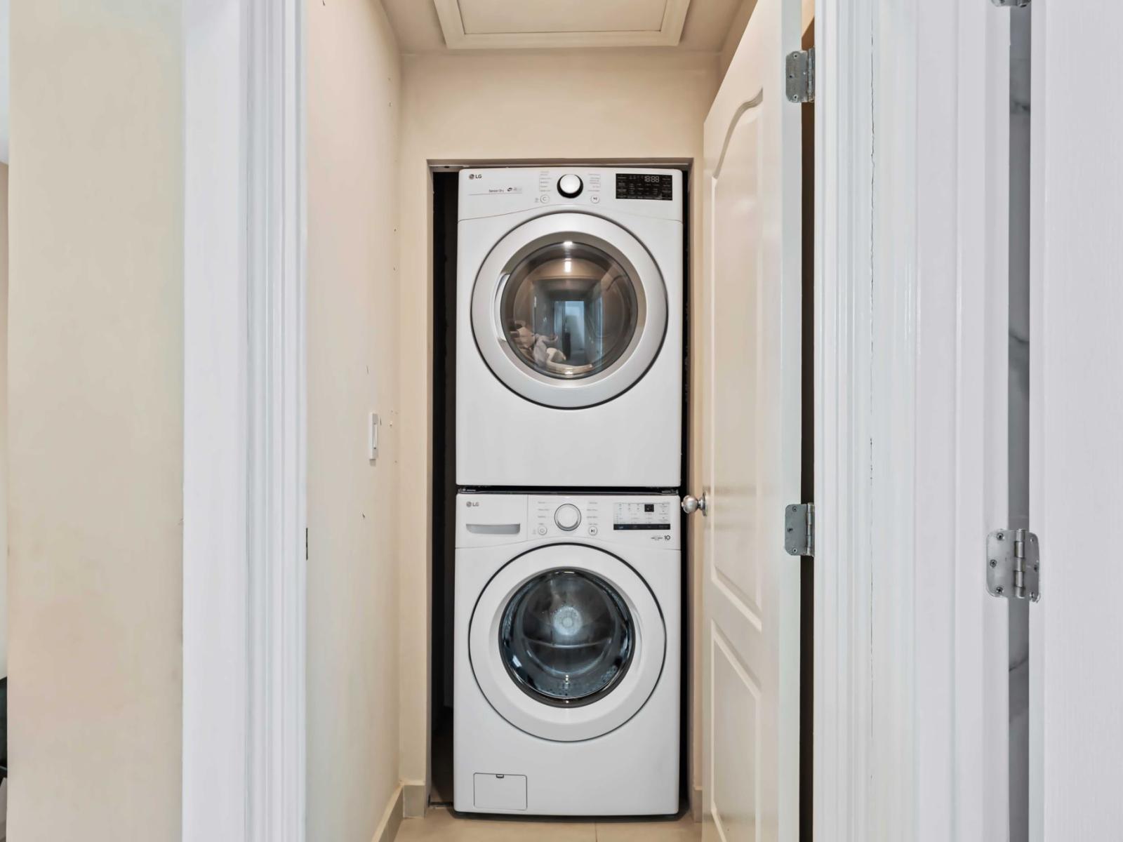 The laundry room is equipped with a convenient stacked washer and dryer set - This setup offers a practical solution for in-home laundry, enhancing convenience for residents - The room is easily accessible, making it simple to manage laundry tasks