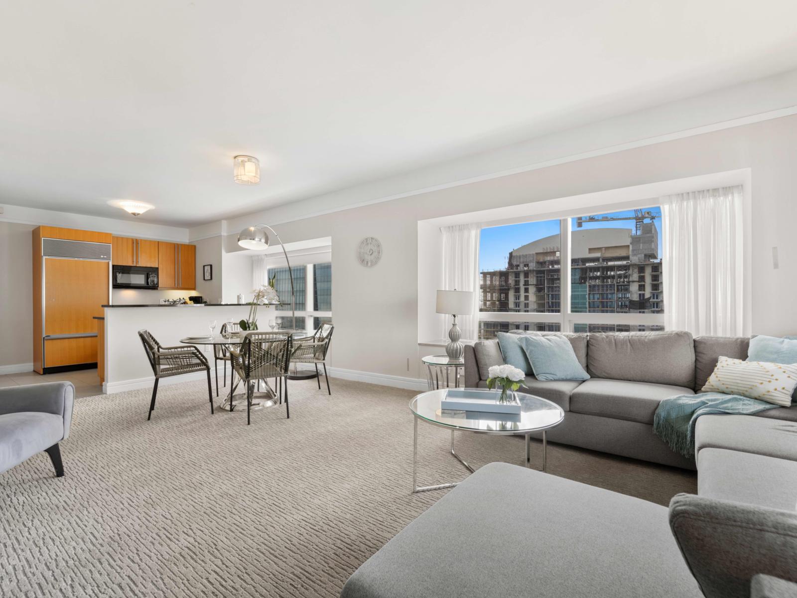 - Relax in open-plan living area with modern decor, ideal for relaxation or entertaining - Large windows provide stunning city views, filling the space with natural light - Fully equipped kitchen with sleek appliances, perfect for home-cooked meals