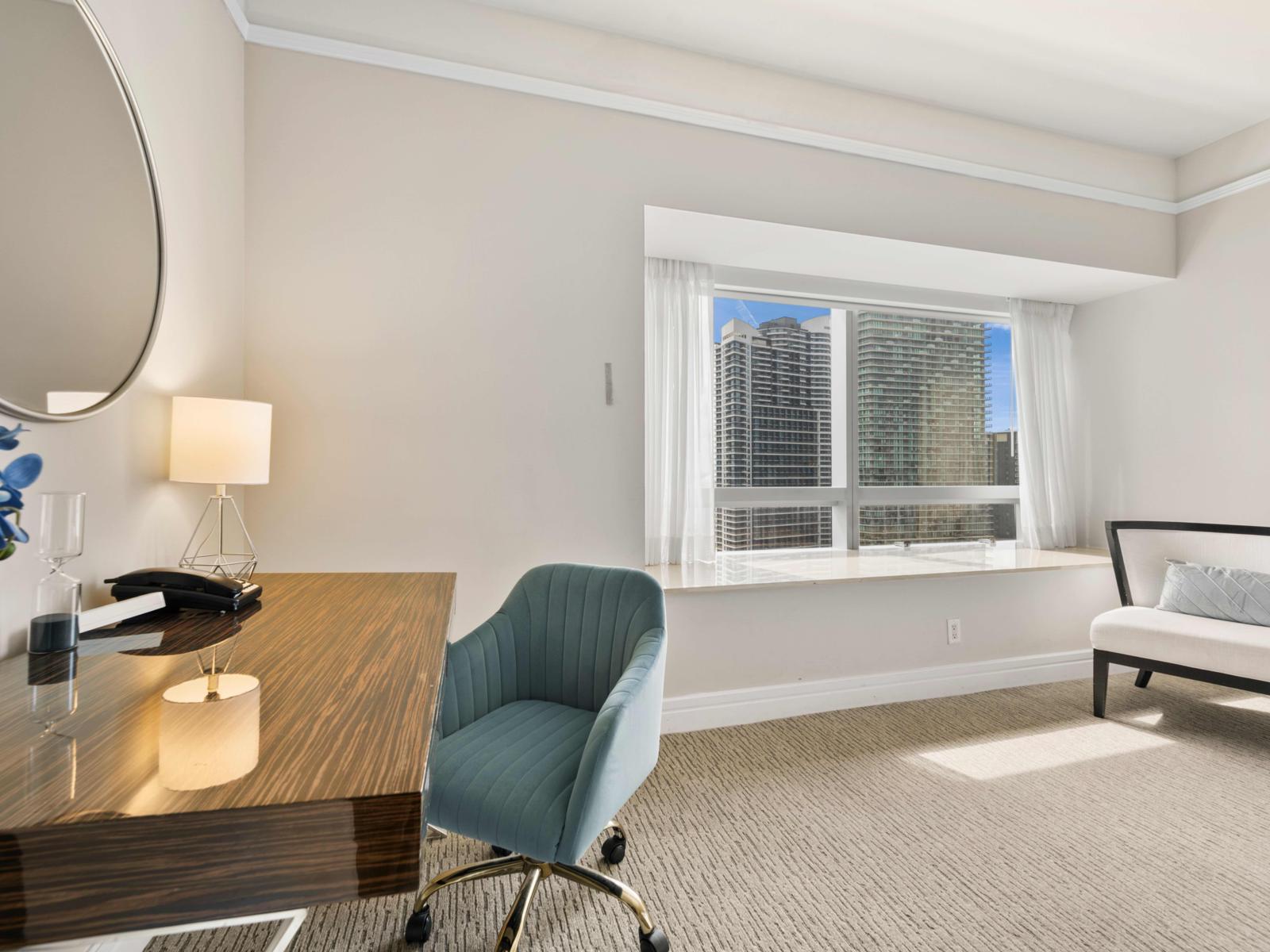 - Bright and inviting workspace in the bedroom, perfect for productivity and relaxation - Large window offers stunning city views, adding inspiration - The cozy seating area by the window is ideal for relaxation or reading in natural light