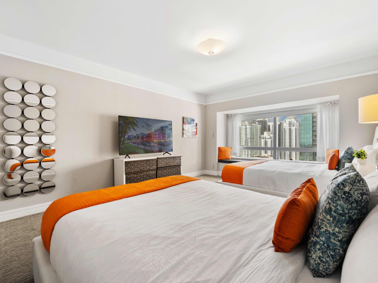 - Relax with modern amenities, including smart  TV, minimalistic decor and stylish mirror - Experience comfort and style in a bright bedroom featuring two double beds - Large windows offer stunning views of Miami’s skyline, bringing in natural light