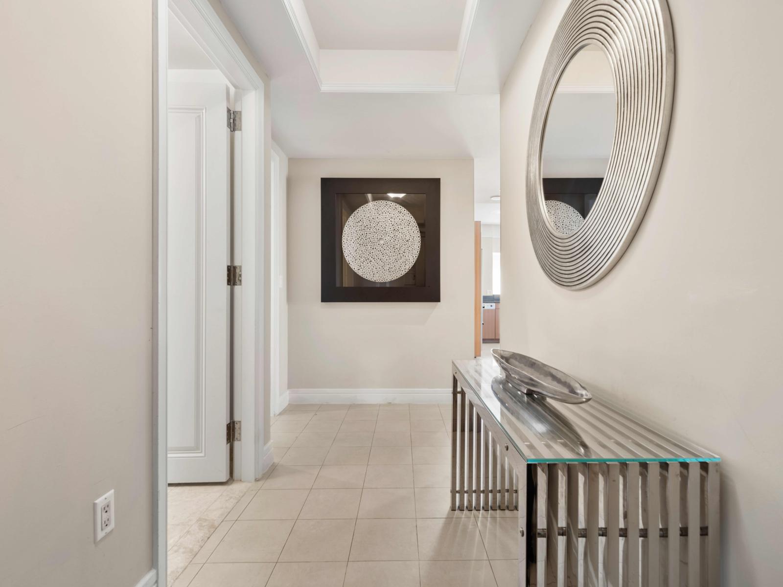 - Step into a beautifully designed hallway that sets the tone - The sleek console table adds a touch of sophistication, perfect for displaying personal touches - Well-lit and inviting, this hallway creates a warm welcome to your stylish retreat