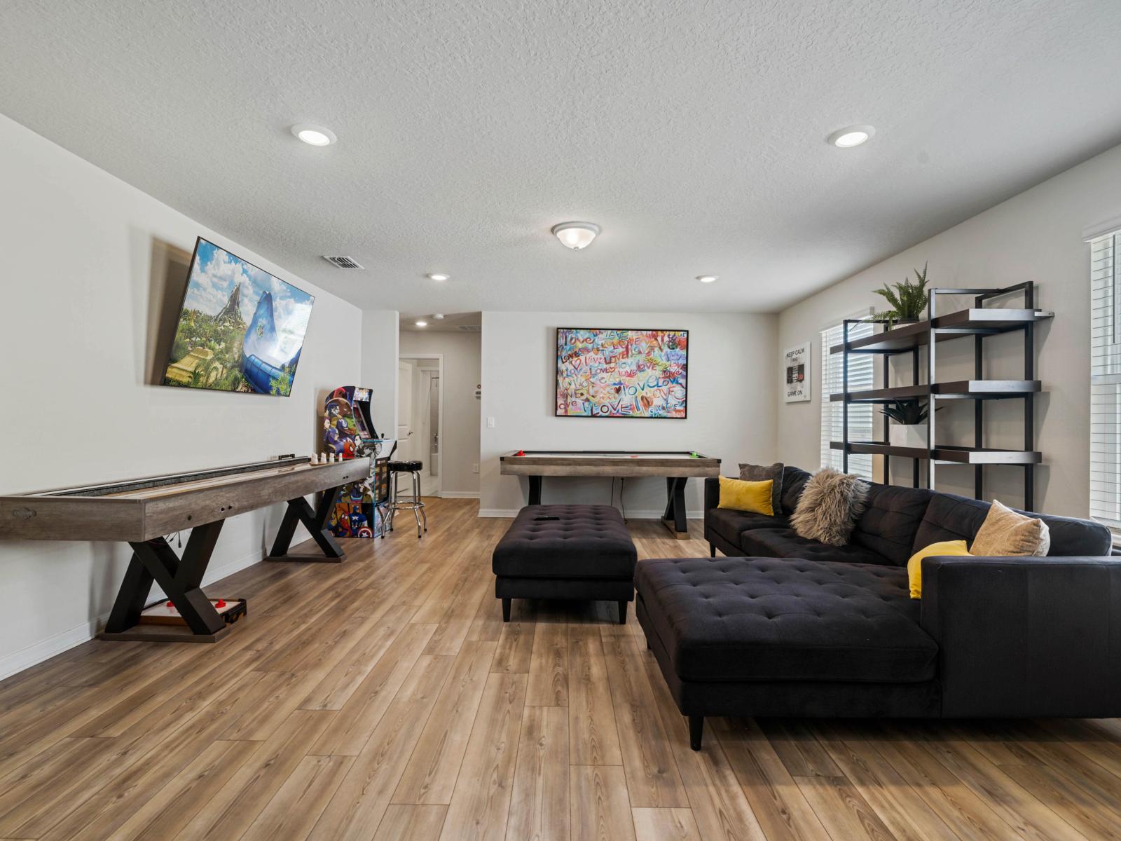 Loft area with arcade games, air hockey table and shuffle table board