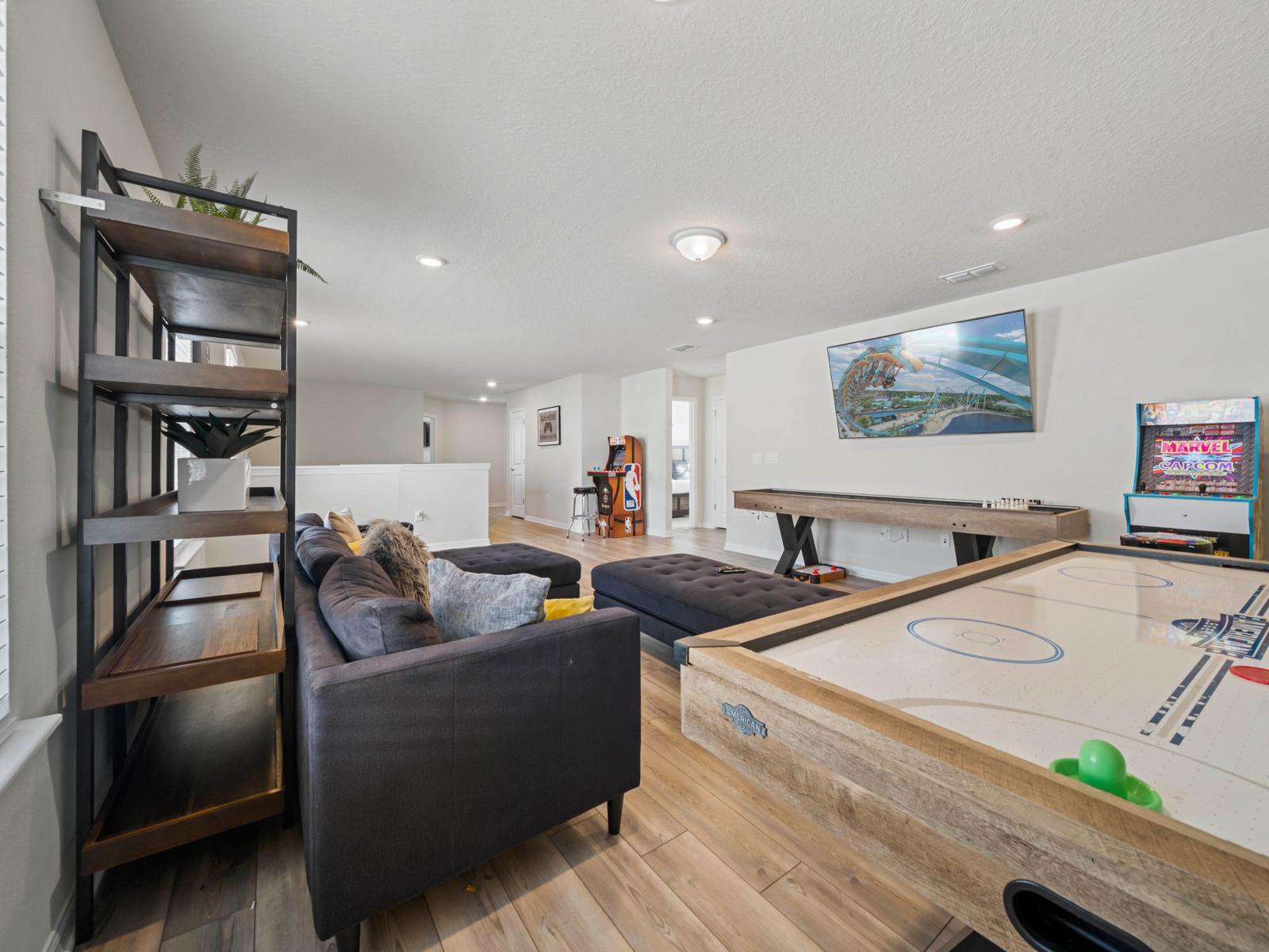 Loft area with arcade games, air hockey table and shuffle table board