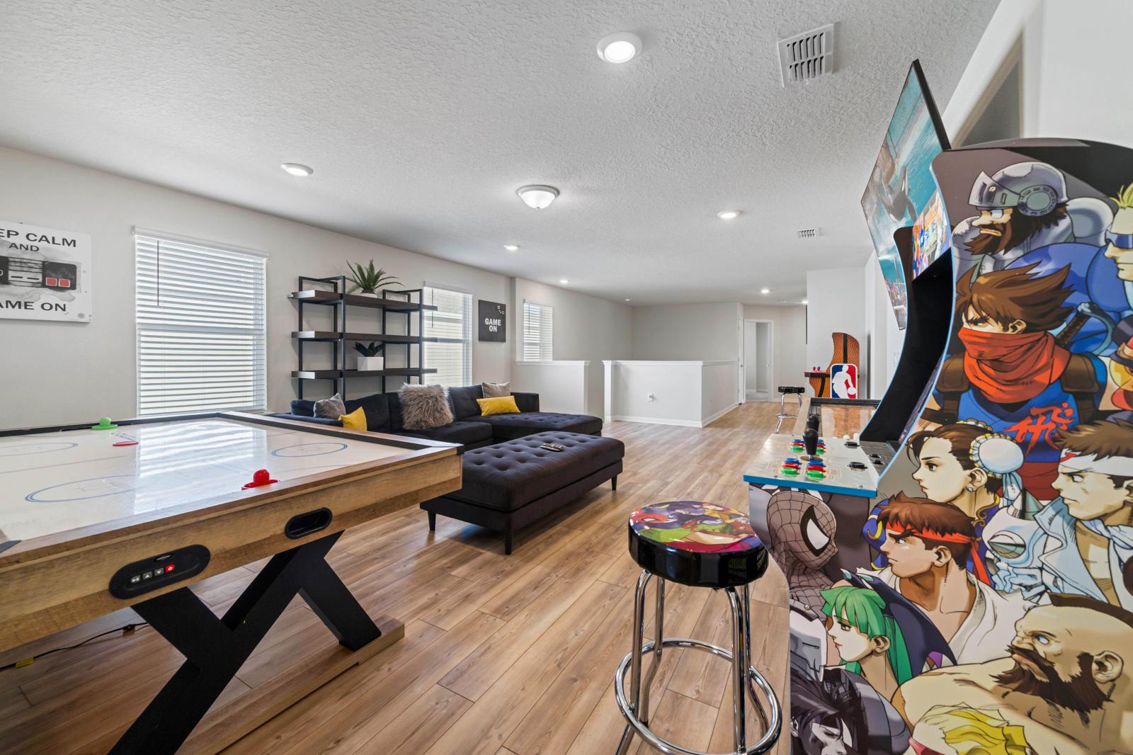 Loft area with arcade games, air hockey table and shuffle table board