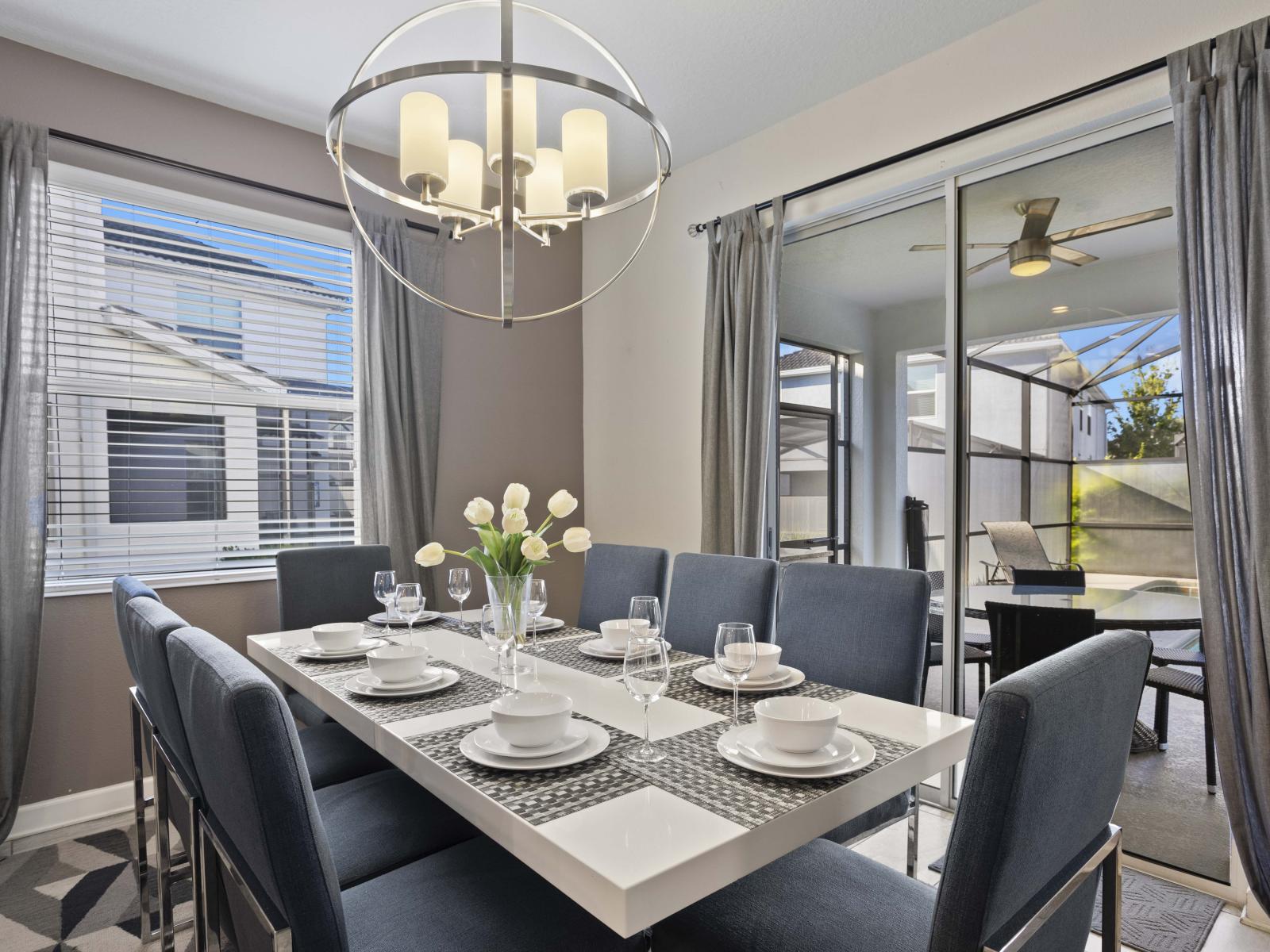 - Gather around a chic dining table that seats eight for memorable meals - Bright and airy dining space, perfect for family dinners or celebrations - Convenient access to the outdoor patio and pool area.