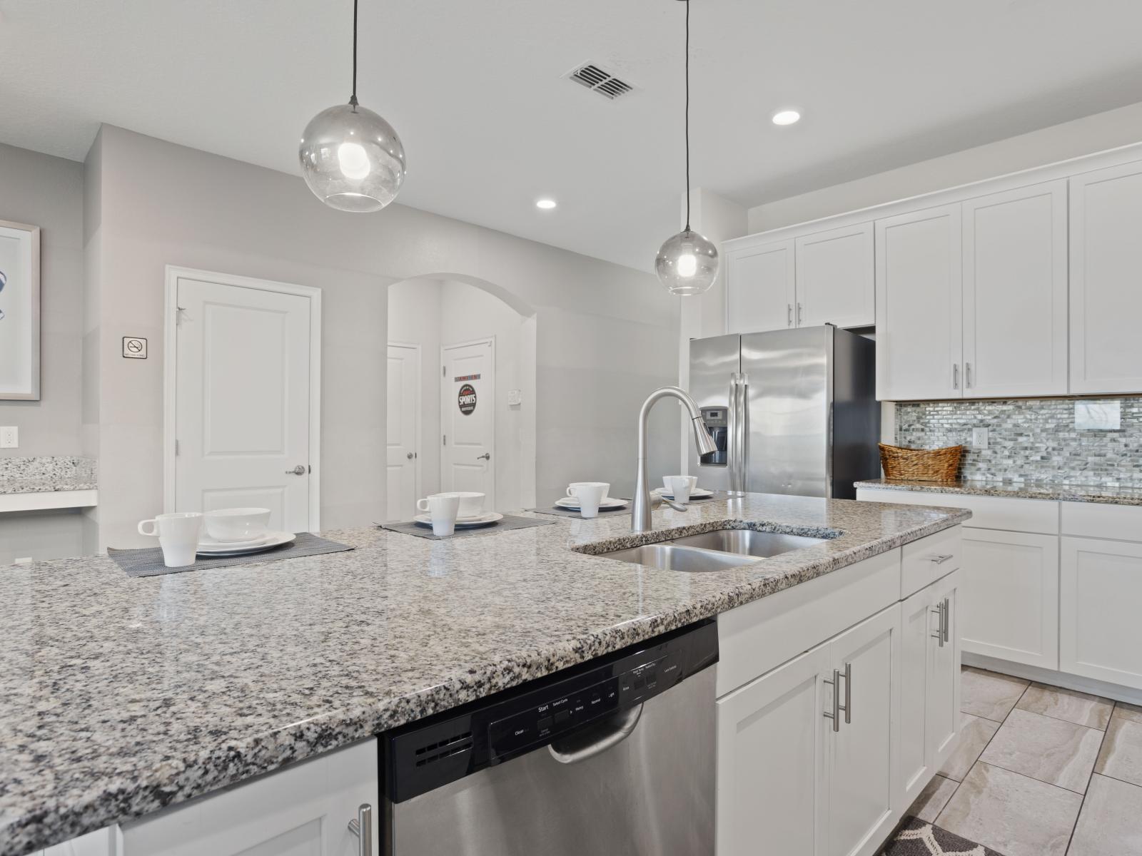 - Sleek kitchen with stainless steel appliances and elegant pendant lighting - Plenty of counter space makes it easy to prepare meals for your group - Modern and fully equipped for all your cooking needs