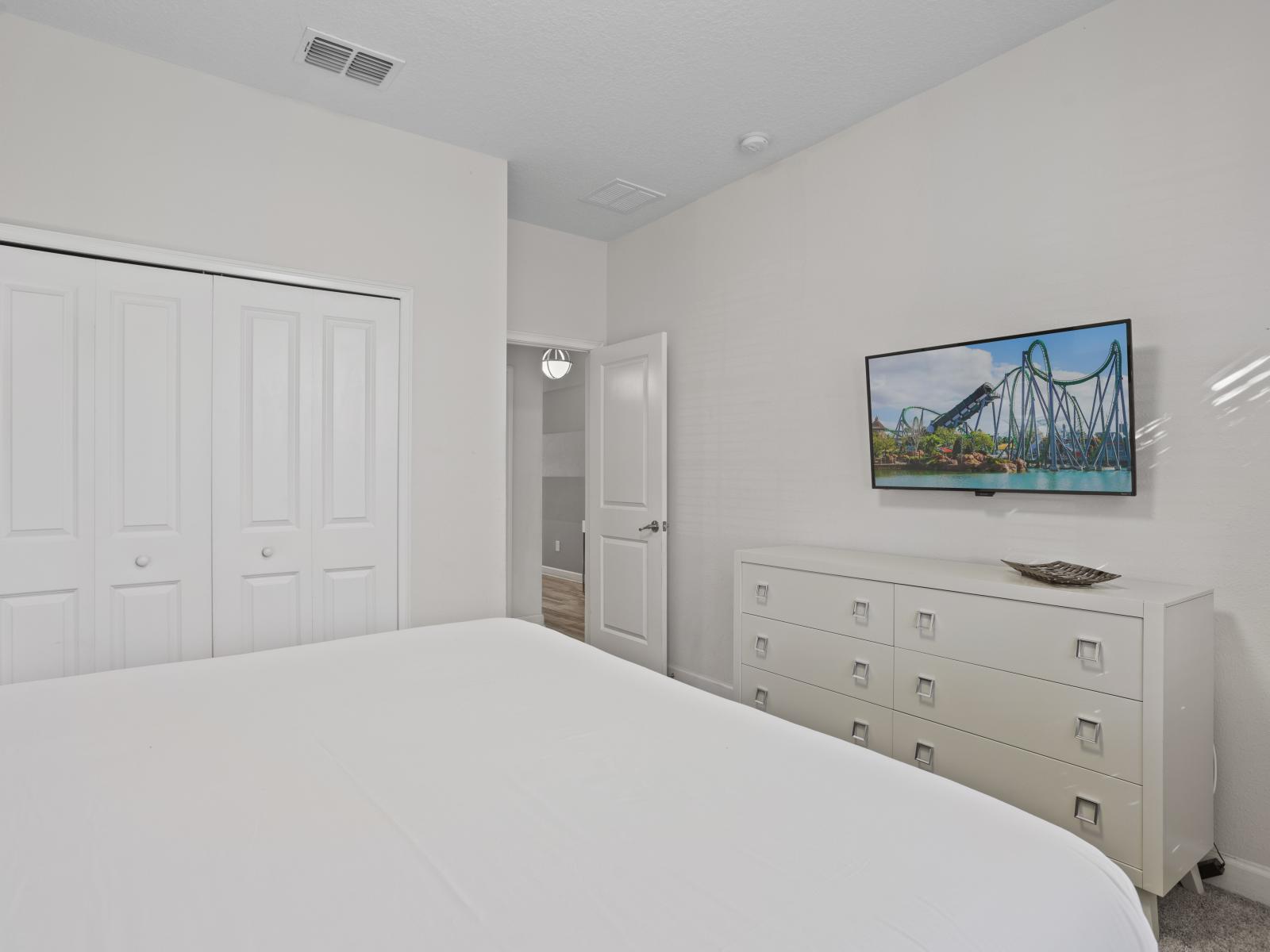 - Unwind in this cozy bedroom featuring a large smart TV and a stylish dresser - The minimalist design and soft bedding ensure a peaceful retreat after a long day - Plenty of closet space makes it easy to store all your belongings for a comfy stay