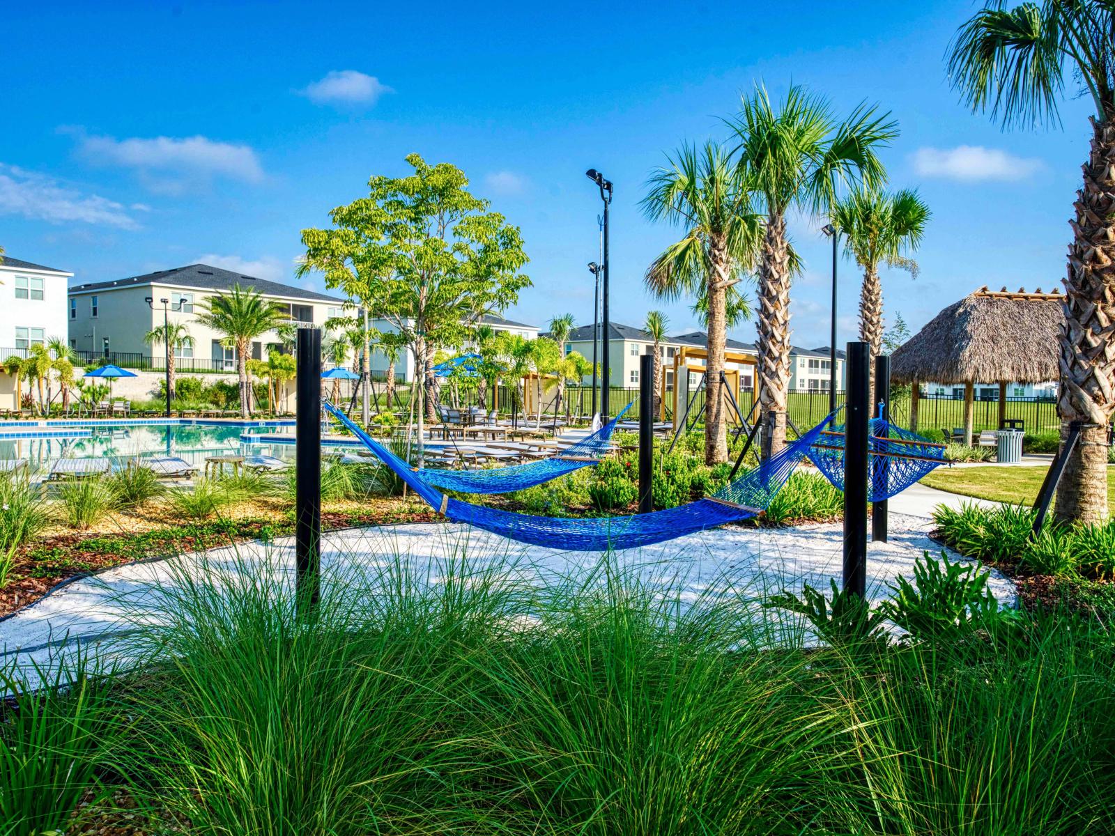 Relax in style with these cozy hammocks surrounded by lush greenery, offering the perfect spot for a peaceful retreat under the sun.