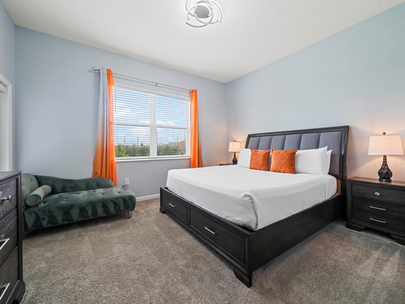 - Spacious bedroom featuring a comfortable king-size bed and a chaise lounge for a restful experience - Private en-suite bathroom for added convenience and privacy - Windows allow plenty of natural light, creating a bright and inviting atmosphere