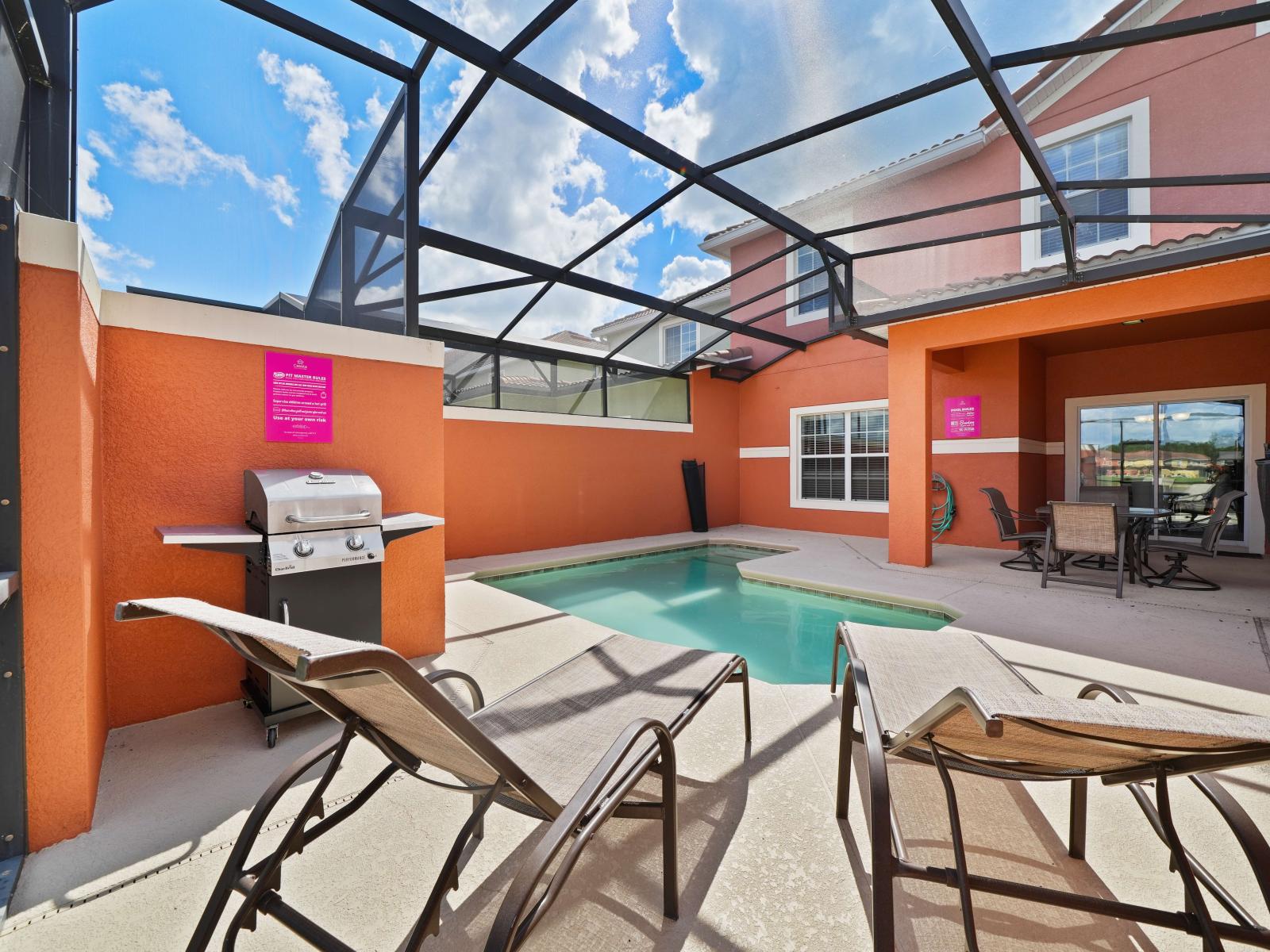 - Outdoor patio with a private pool, perfect for relaxing under a screened enclosure - Comfortable lounge chairs and a gas grill offer options for both sunbathing and outdoor cooking - Bright orange walls and sunny weather create a vibrant atmosphere