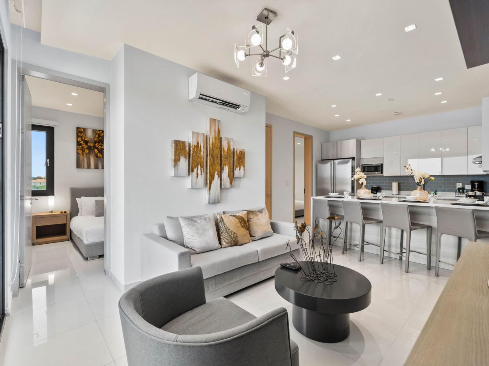 - Step inside this modern living area with contemporary design and plenty of natural light - Comfortable seating and stylish décor make this a perfect spot to relax - Open-plan layout connecting the living room to the kitchen for easy flow