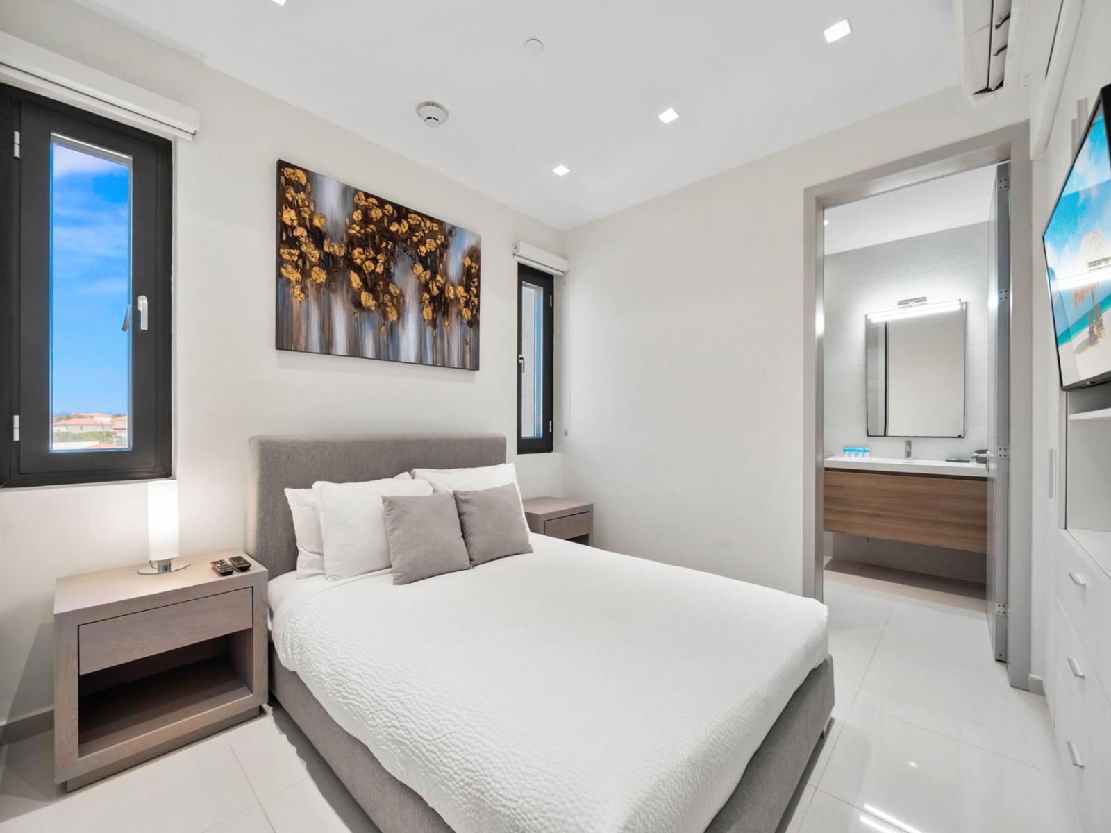 -  Relax in this bright and airy bedroom with a clean, minimalist design for a restful stay - A plush double bed with soft linens ensures comfort after a long day - Modern ensuite bathroom for convenience and privacy during your stay