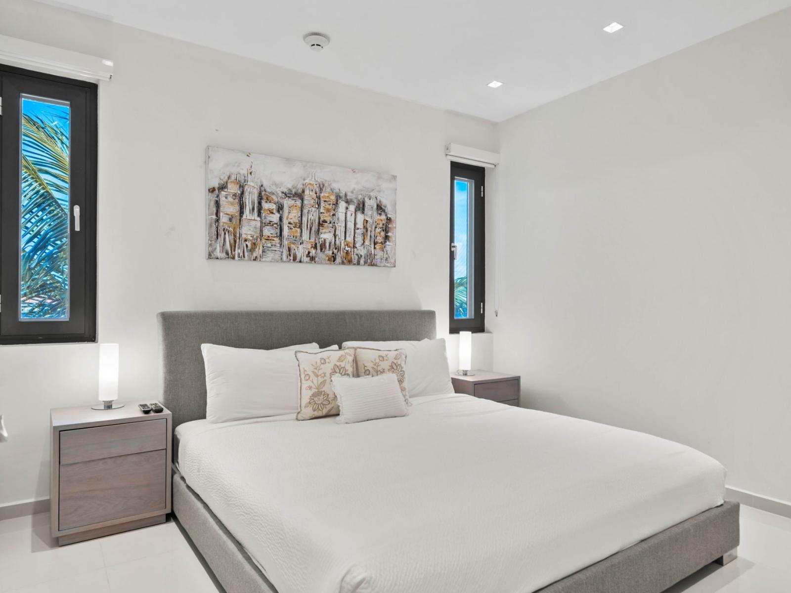 - Spacious bedroom with a luxurious double bed and contemporary artwork - Large windows bring in natural light, offering a serene and relaxing atmosphere - Perfect for unwinding after a long day, with modern comforts and thoughtful decor