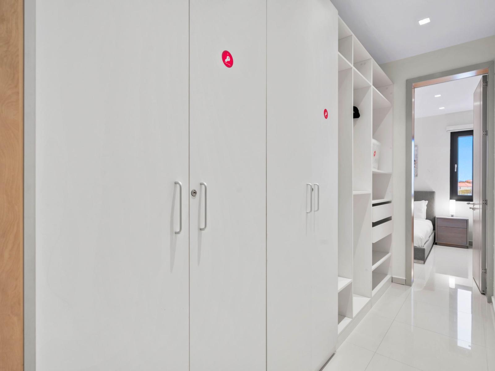 - A sleek hallway leading to the inviting bedroom, lined with closets for storage - Clean, contemporary design throughout the space offers a modern feel - Perfect for keeping all your travel belongings organized and tucked away