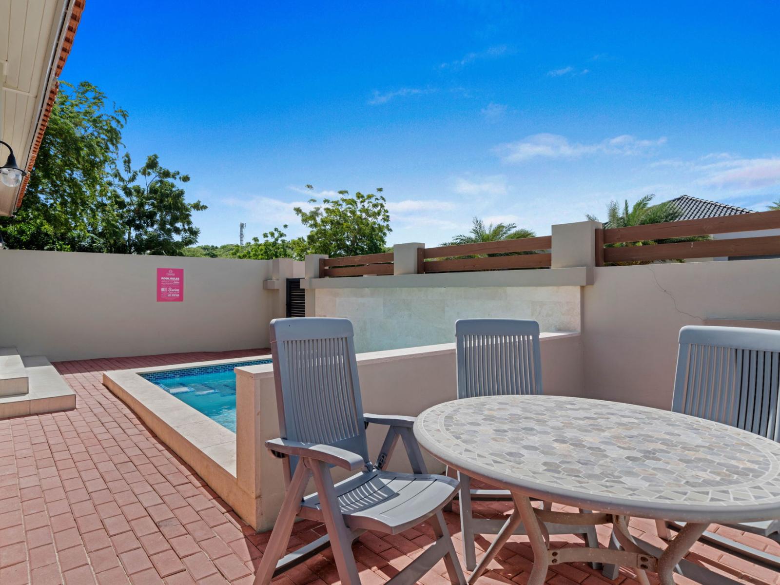 - Dine al fresco by the pool in this cozy outdoor seating area, perfect for any meal - Enjoy sunny mornings or breezy evenings with the calming sound of the water nearby - Tranquil & private space designed for relaxation & connection with loved ones