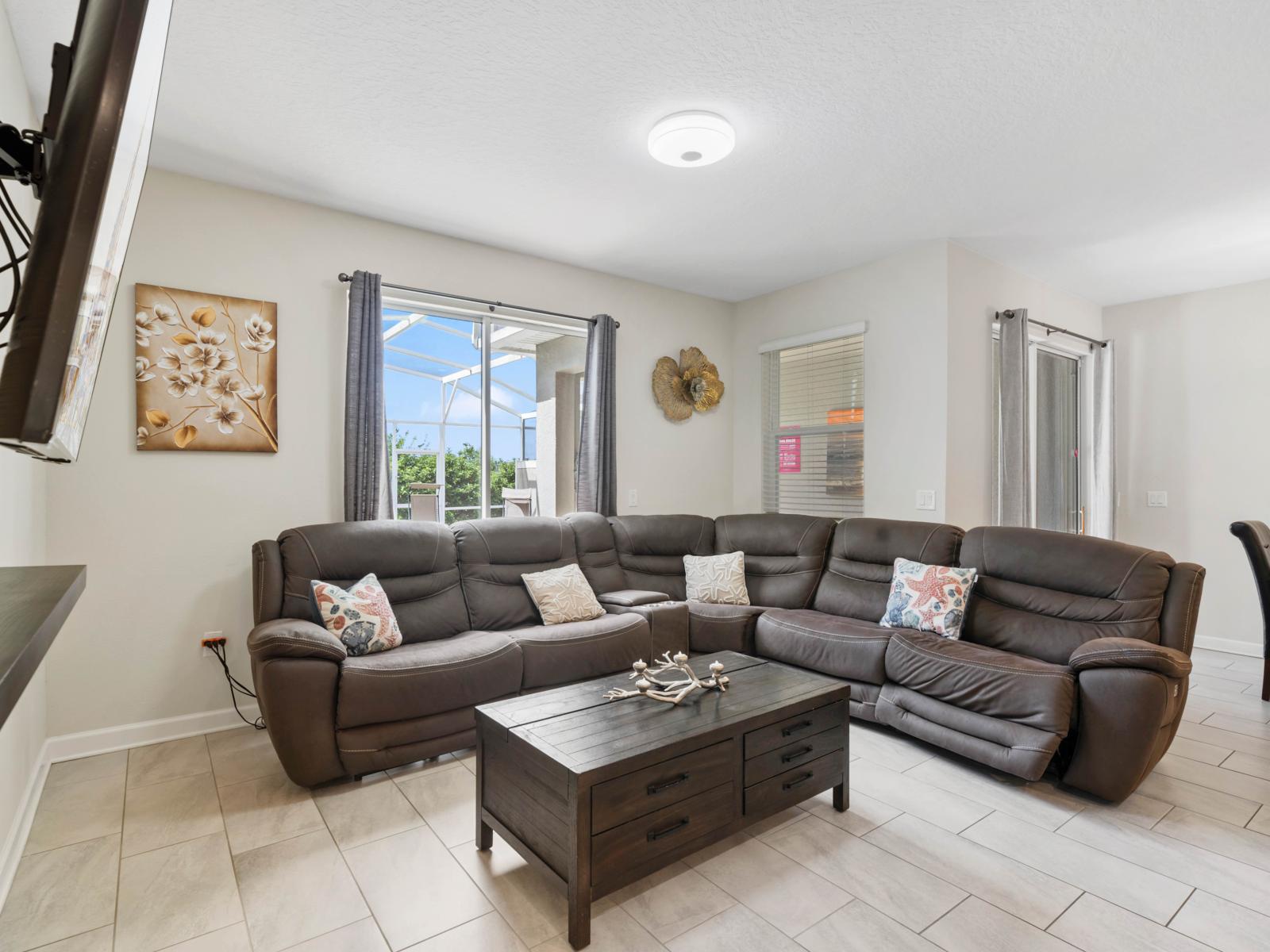 Enjoy a movie night in this inviting living space, equipped with a large screen and comfortable seating.