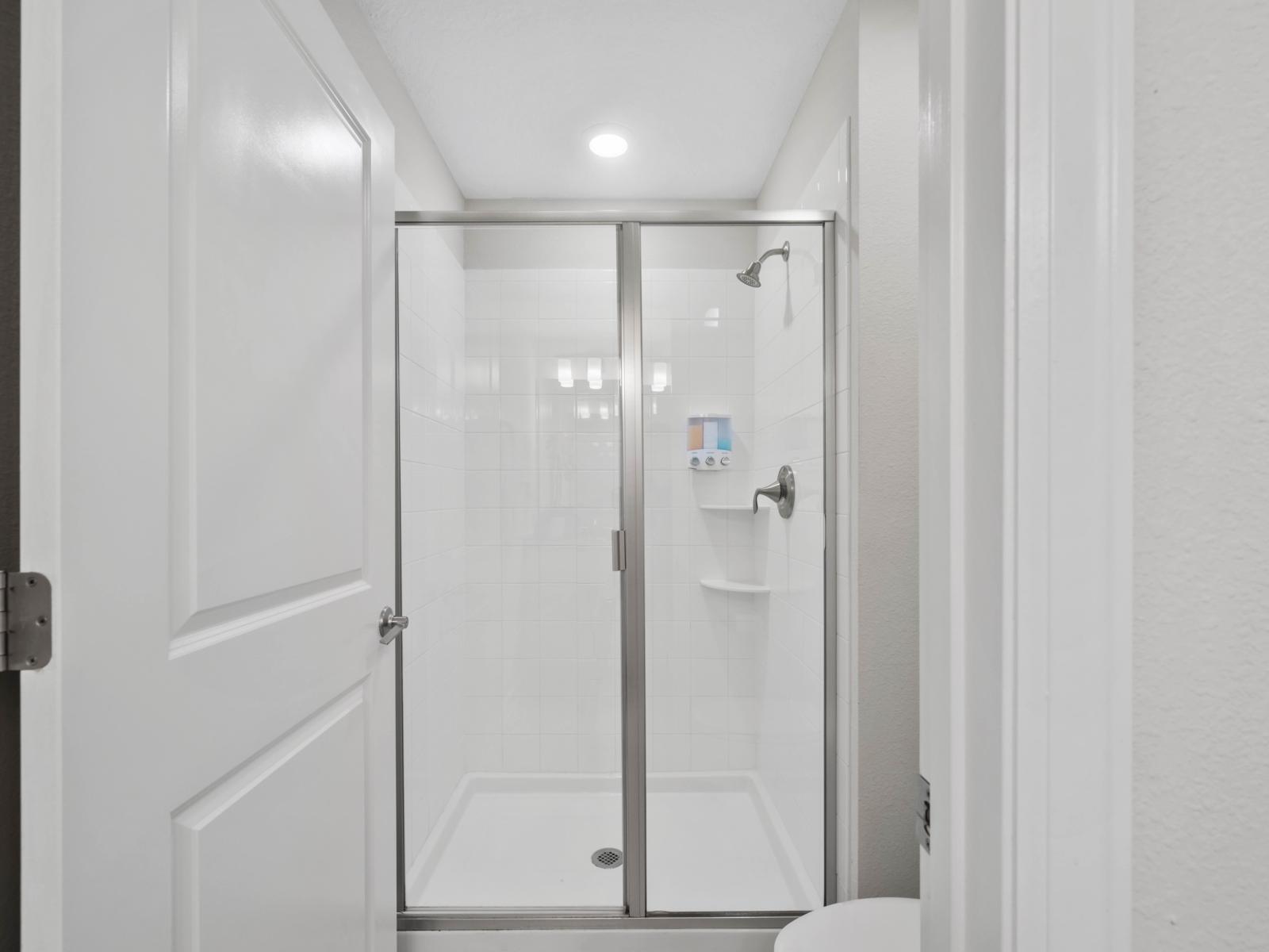 Sleek & Stylish: Enjoy a contemporary bathroom featuring a spacious walk-in shower, perfect for unwinding after a long day.