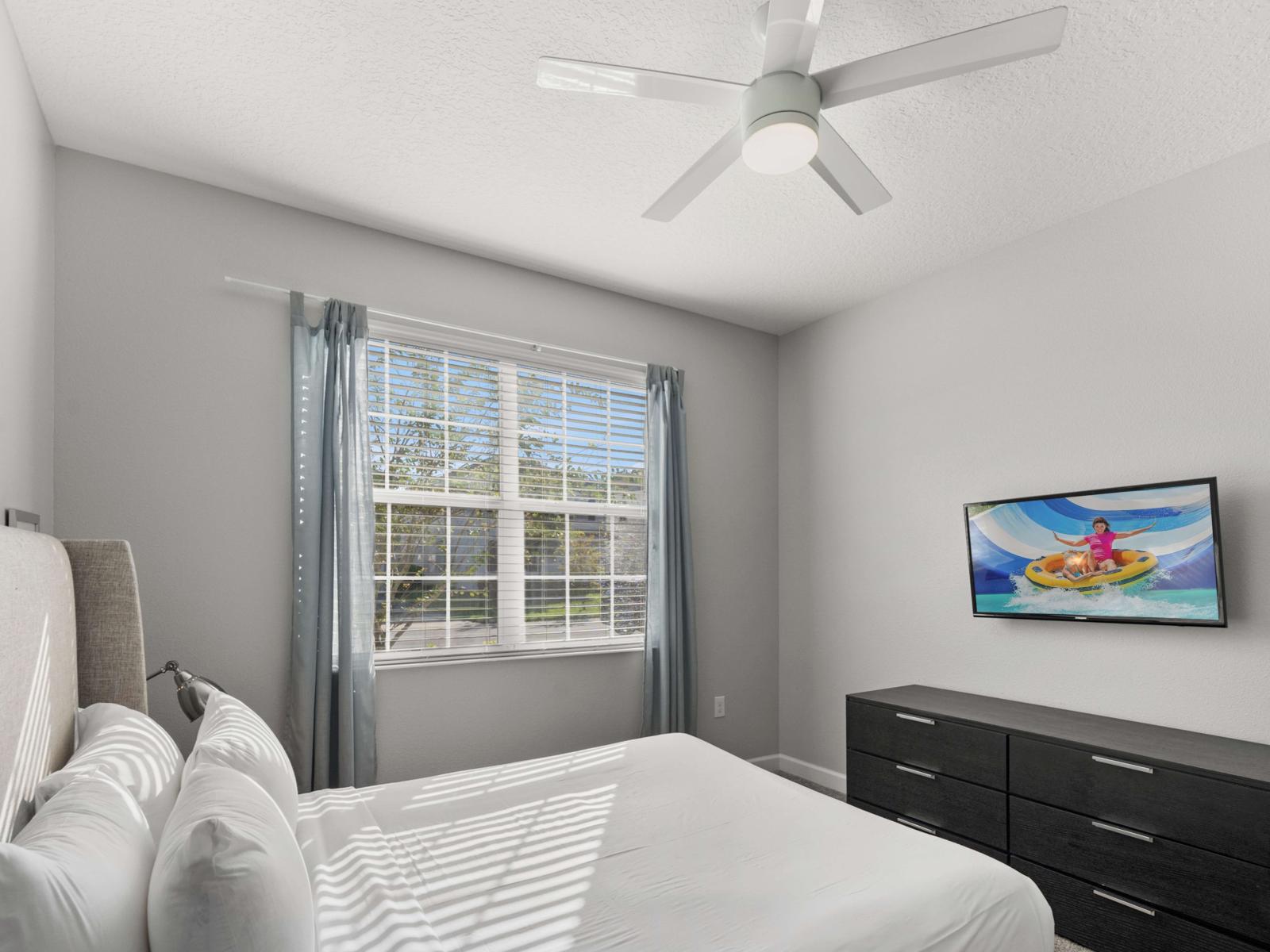 Wake up refreshed in this vibrant bedroom with a flat-screen TV – ideal for morning shows or evening movies.