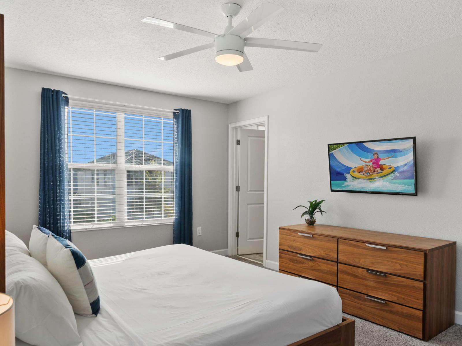 Spacious king bedroom with vibrant decor and a TV – your private sanctuary for rest and entertainment.