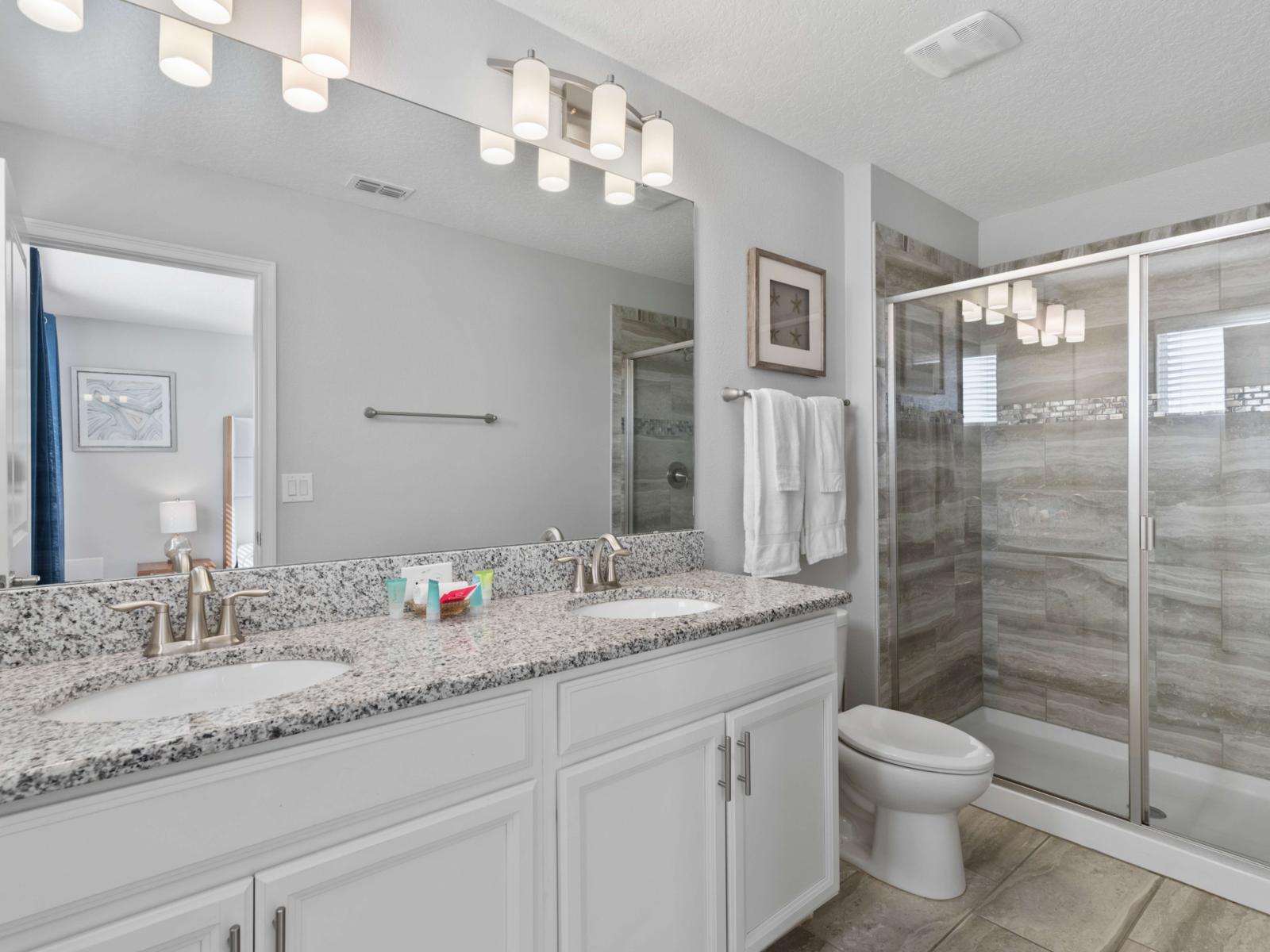 En-Suite Bathroom:  Step into your private en-suite with a glass-enclosed walk-in shower, quality toiletries, and plush towels, making mornings a breeze.